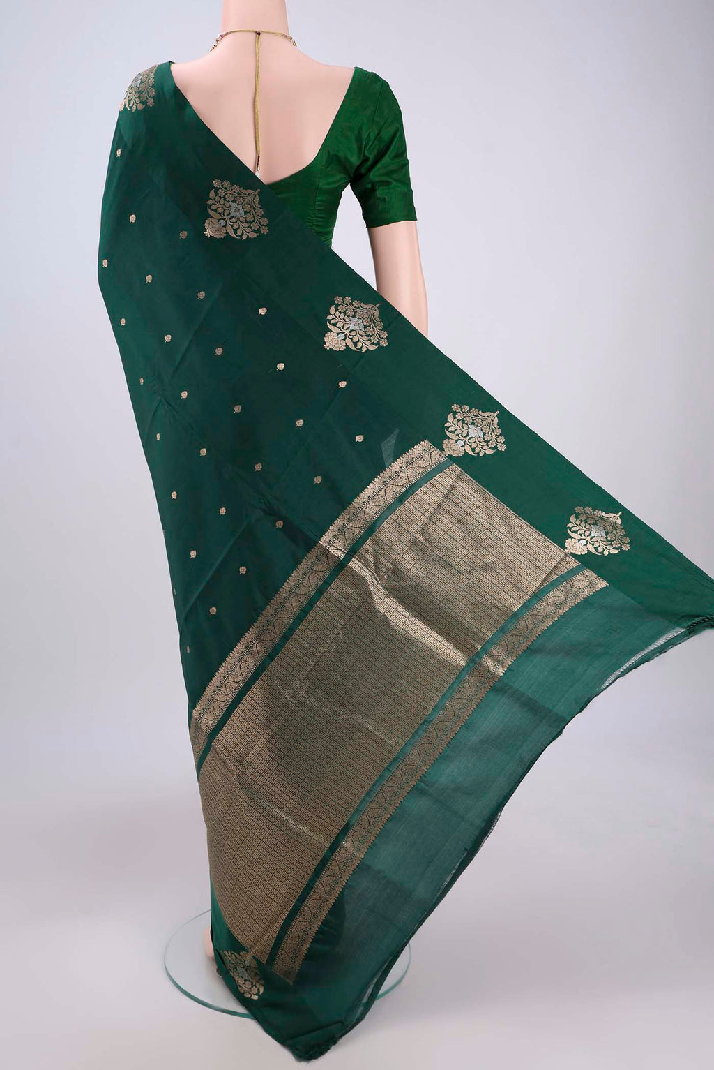 Flat view of Green Banarasi Katan Silk Saree with Zari Butta on the body and Zari Border. 