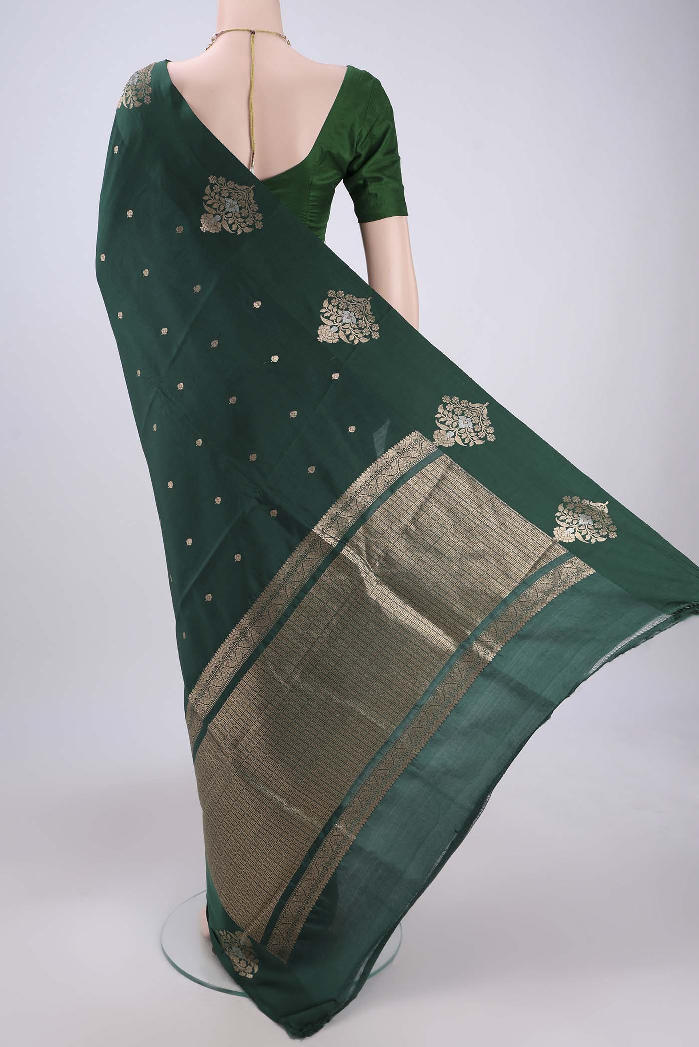 Flat view of Green Banarasi Katan Silk Saree with Zari Butta on the body and Zari Border. 