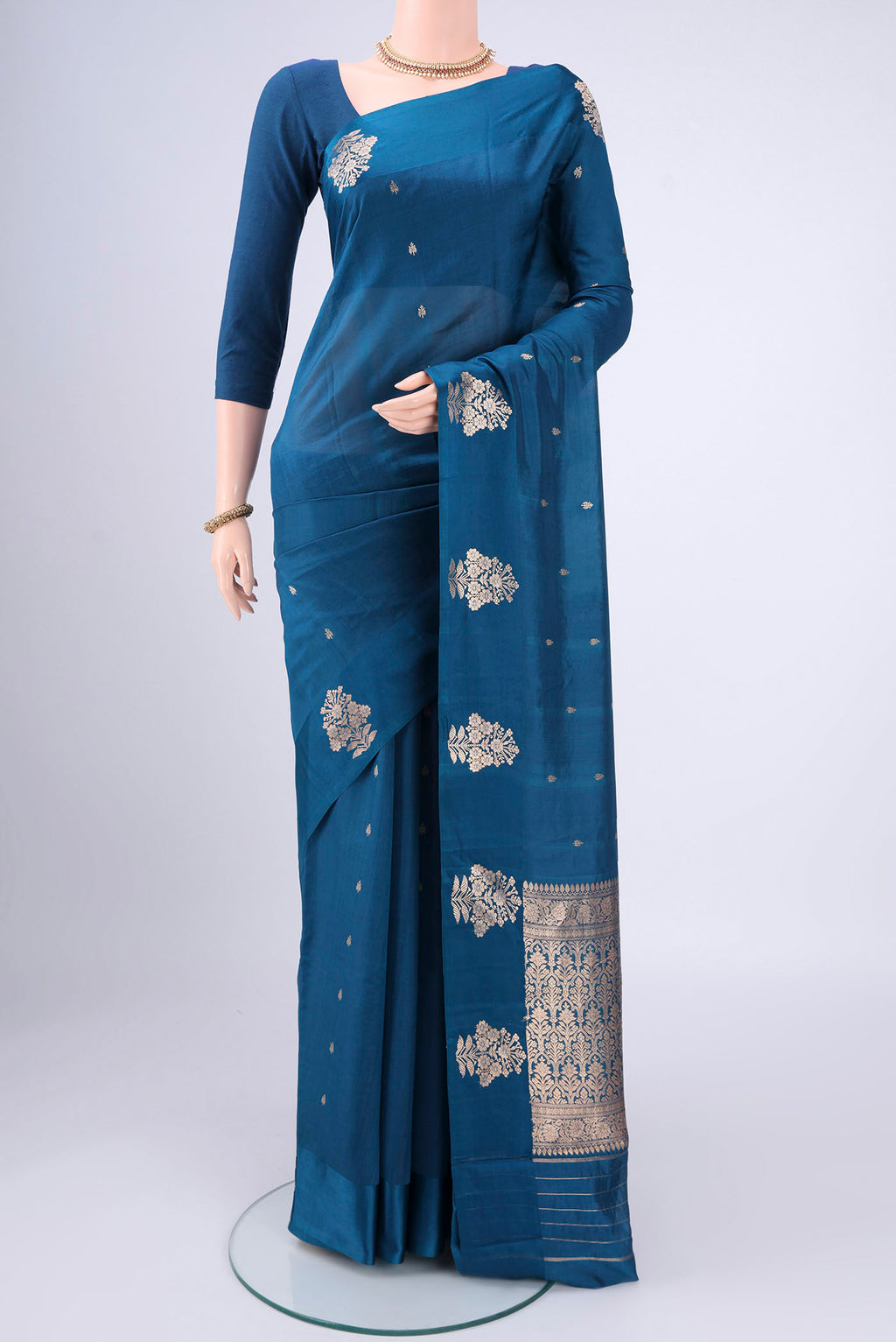 Blue Banarasi Katan Silk Saree with Zari Butta on the body and Zari Border.  displayed on a mannequin