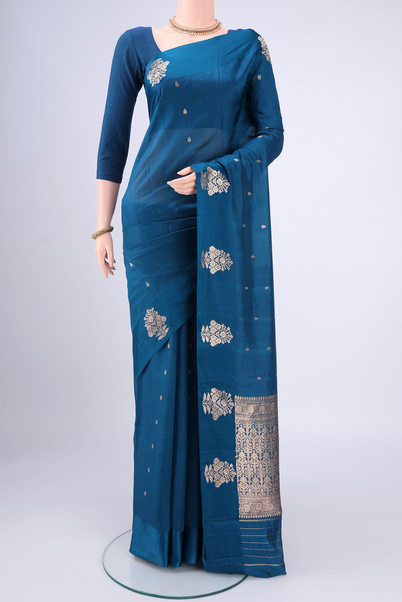 Blue Banarasi Katan Silk Saree with Zari Butta on the body and Zari Border.  displayed on a mannequin