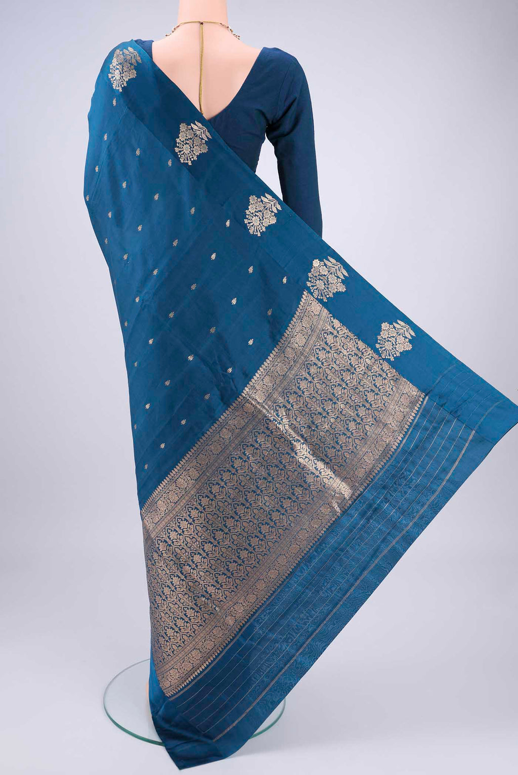Flat view of Blue Banarasi Katan Silk Saree with Zari Butta on the body and Zari Border. 