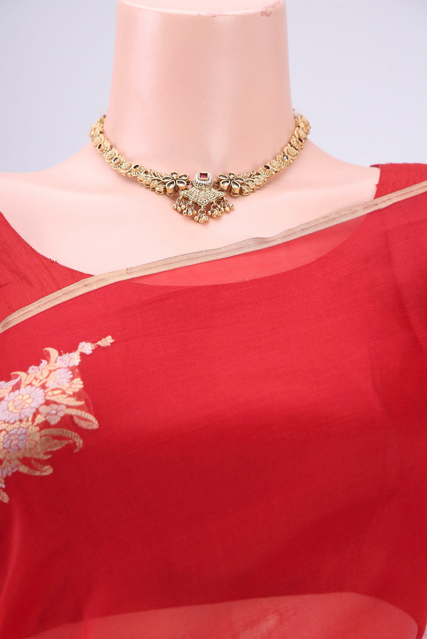 Border image of Red Organza Silk Saree with Zari Butta on the body and Thin Zari Line. 