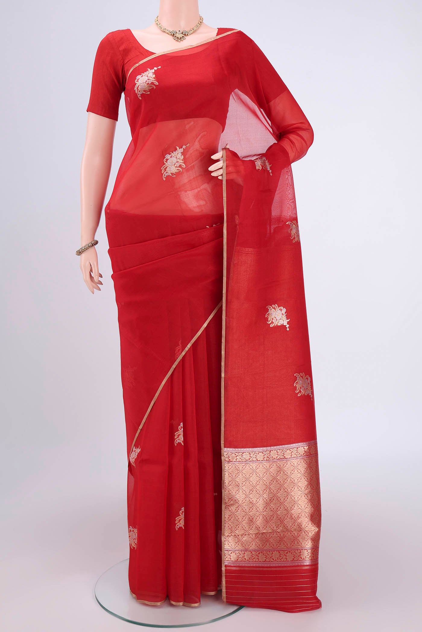 Red Organza Silk Saree with Zari Butta on the body and Thin Zari Line.  displayed on a mannequin