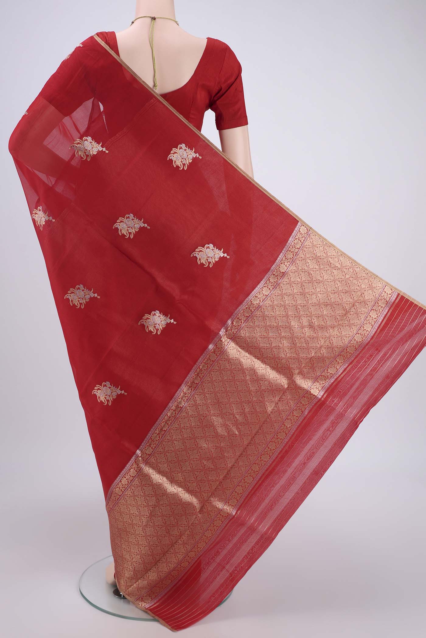 Flat view of Red Organza Silk Saree with Zari Butta on the body and Thin Zari Line. 