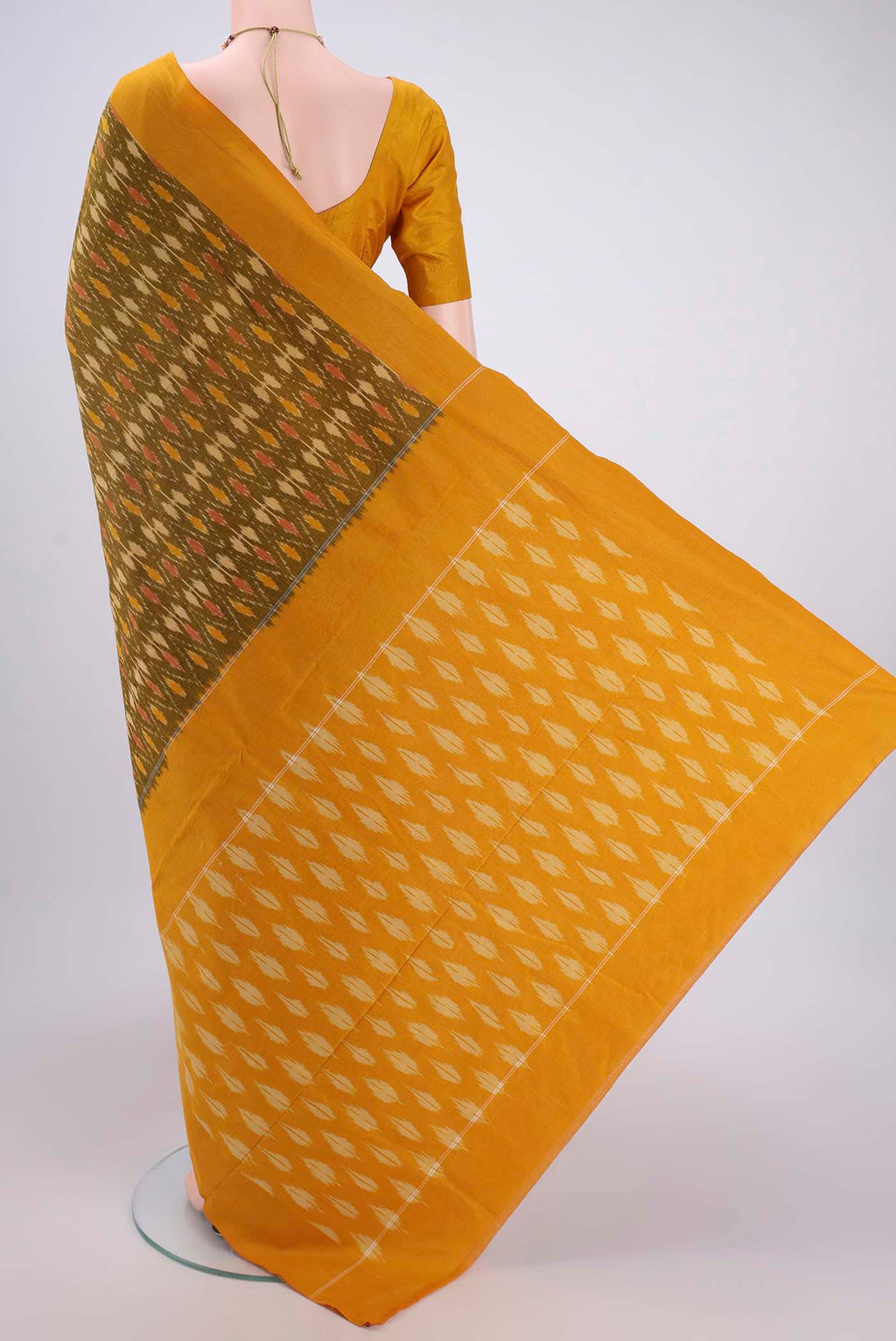 Flat view of Mehandi Green Pochampally Cotton Saree with Ikat design on the body and Ikat Border. 