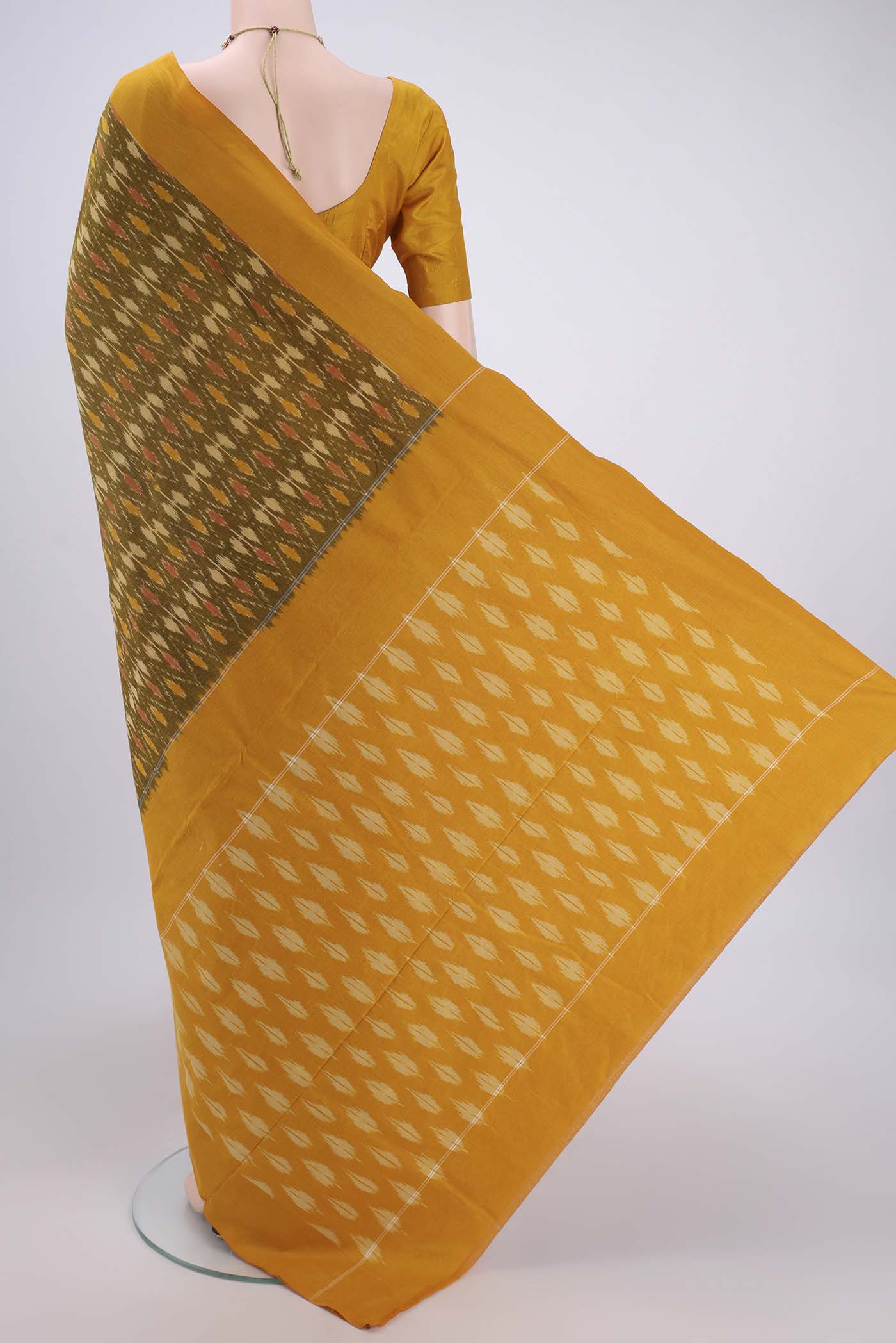 Flat view of Mehandi Green Pochampally Cotton Saree with Ikat design on the body and Ikat Border. 