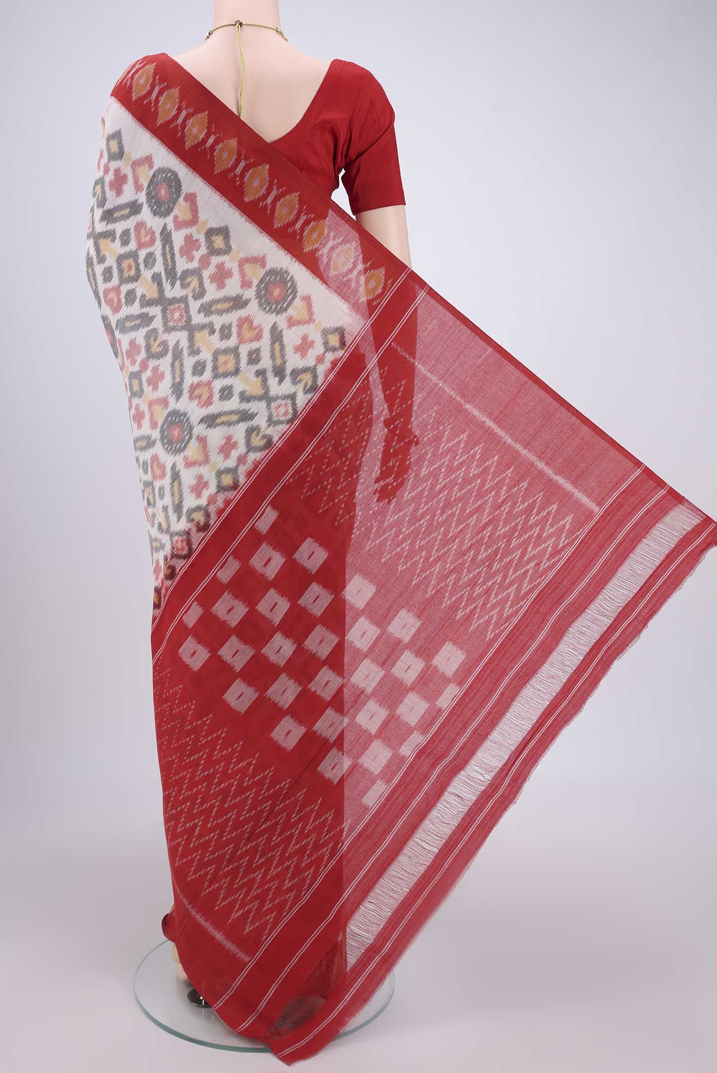 Flat view of White Pochampally Cotton Saree with Ikat design on the body and Ikat Border. 
