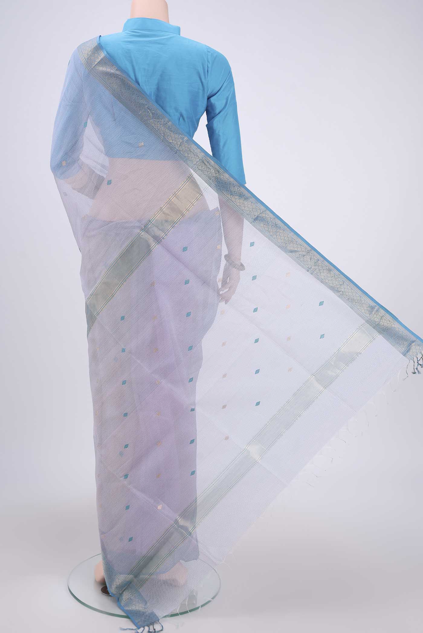 Flat view of Lilac Maheshwari Silk Cotton Saree with Zari And Thread Butta on the body and Zari Border. 