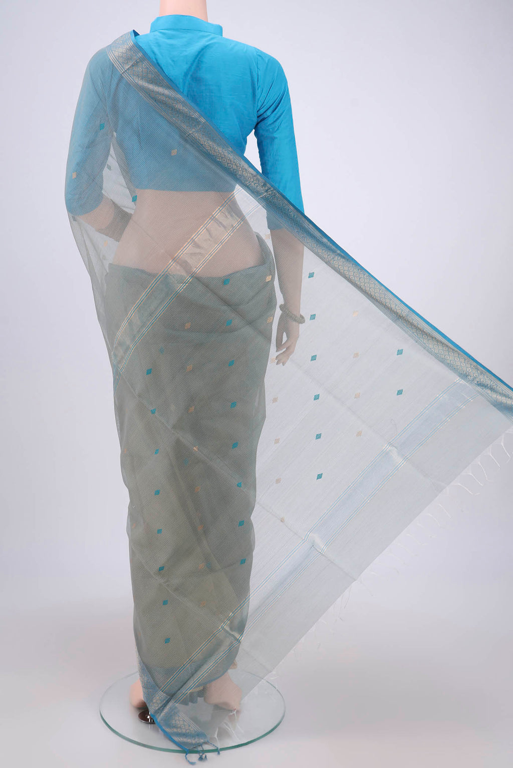 Flat view of Beige Maheshwari Silk Cotton Saree with Zari And Thread Butta on the body and Zari Border. 