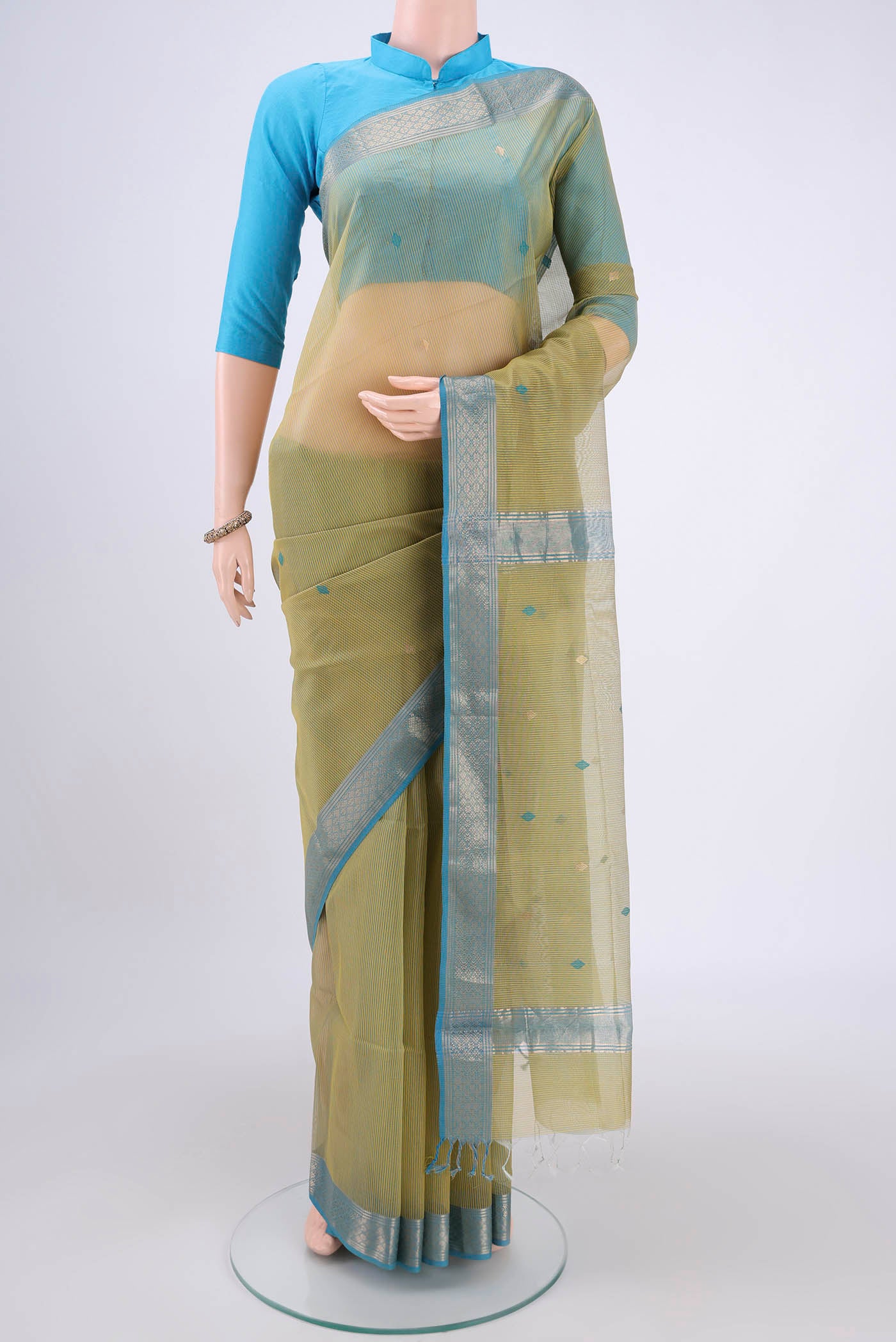 Yellow Maheshwari Silk Cotton Saree with Zari And Thread Butta on the body and Zari Border.  displayed on a mannequin