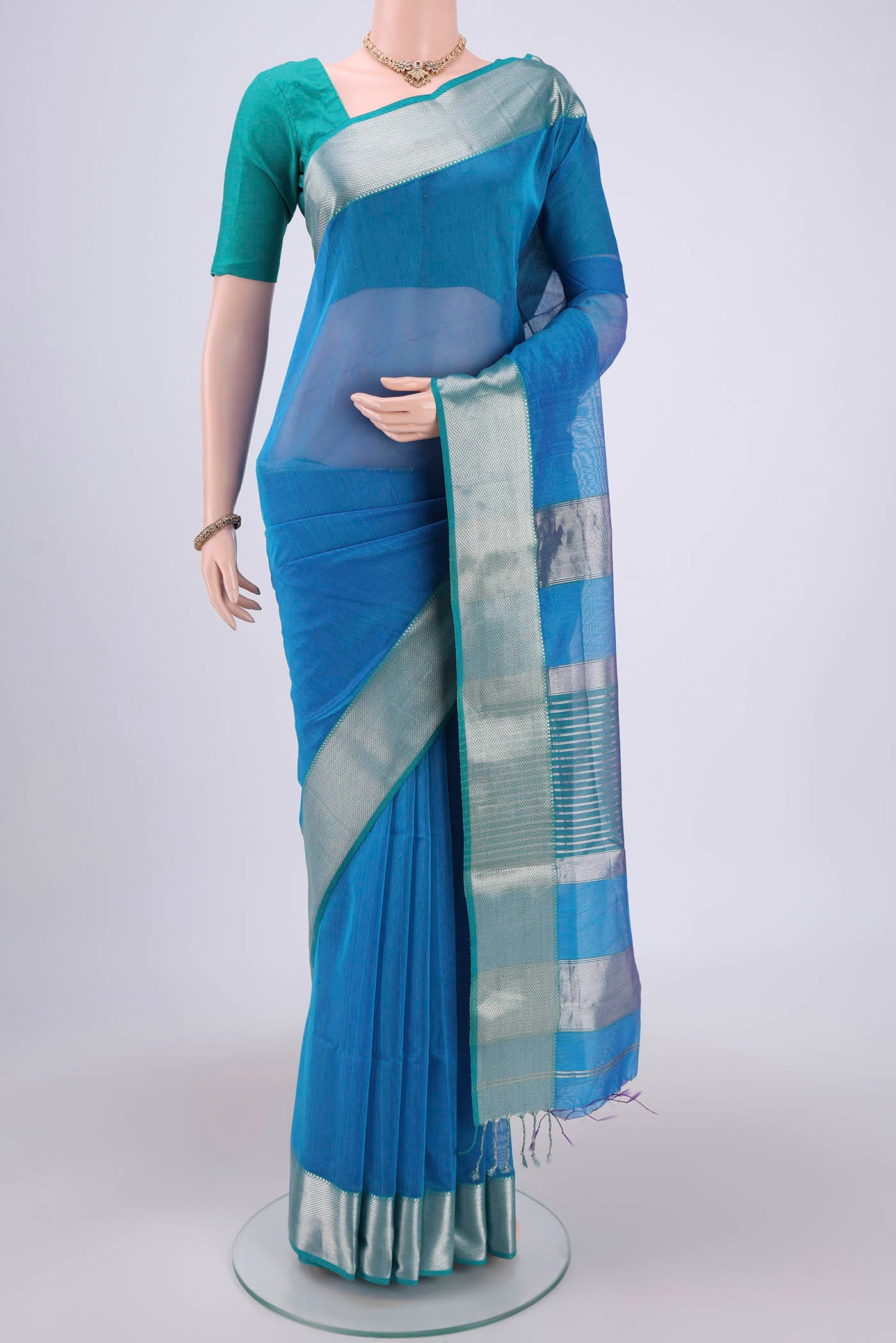 Turquoise Maheshwari Silk Cotton Saree with Plain Body and Zari Border.  displayed on a mannequin
