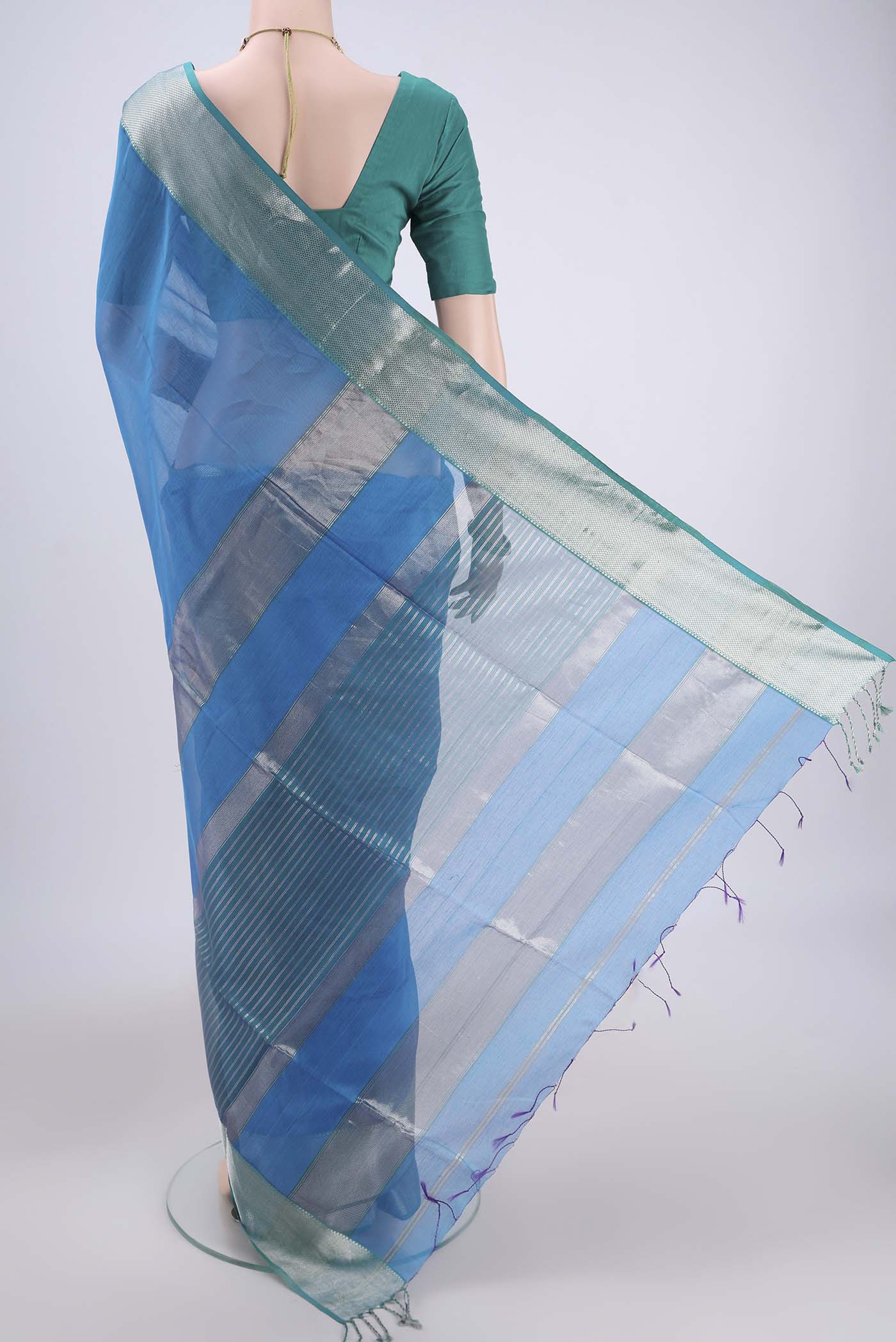 Flat view of Turquoise Maheshwari Silk Cotton Saree with Plain Body and Zari Border. 