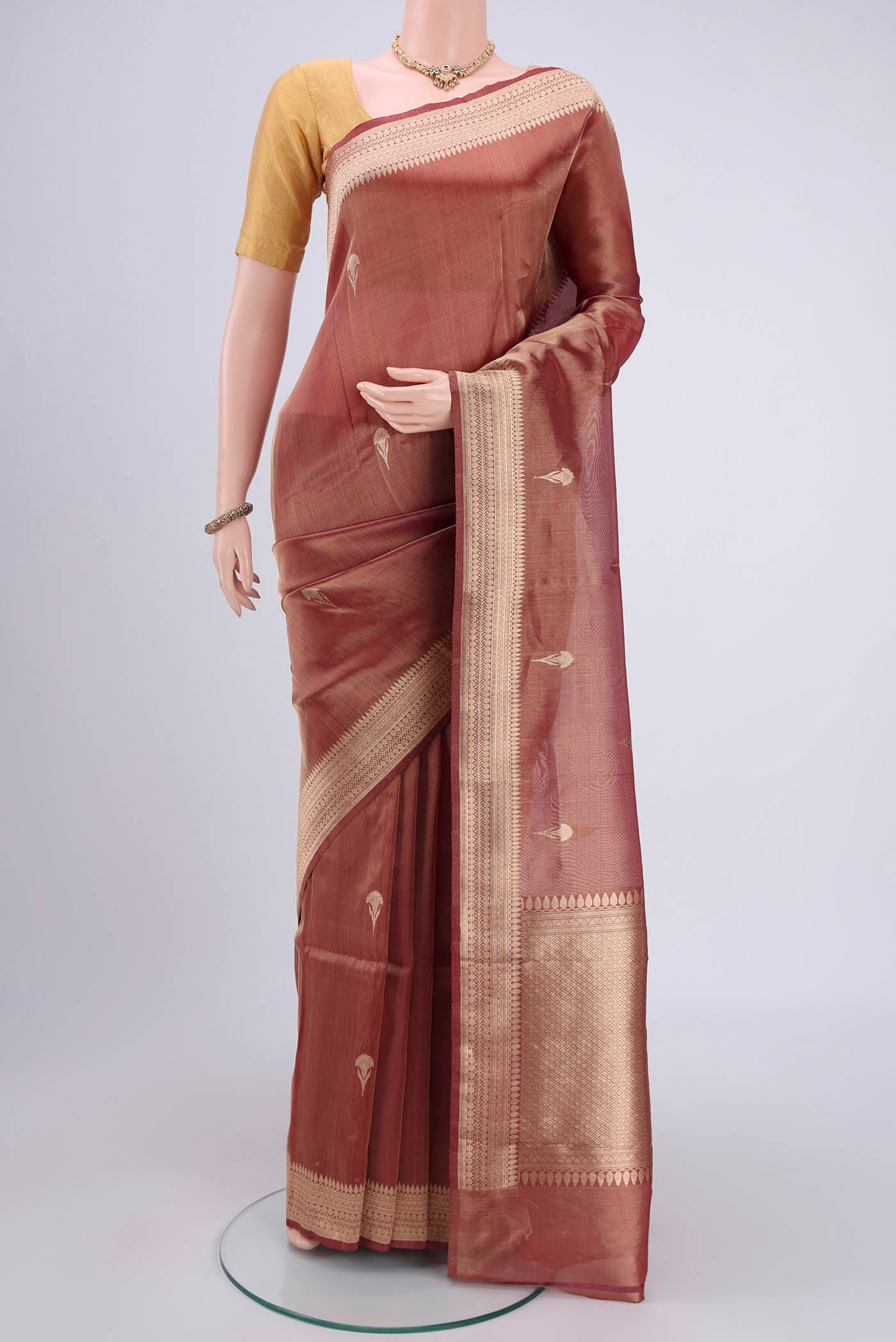 Maroon Banarasi Tissue Silk Saree with Zari Butta on the body and Zari Border.  displayed on a mannequin