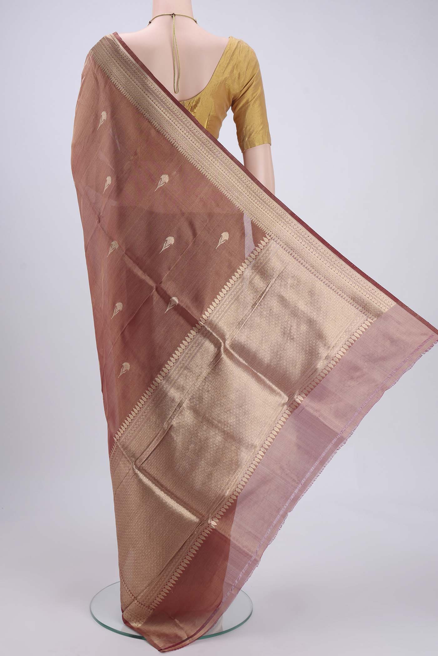 Flat view of Maroon Banarasi Tissue Silk Saree with Zari Butta on the body and Zari Border. 