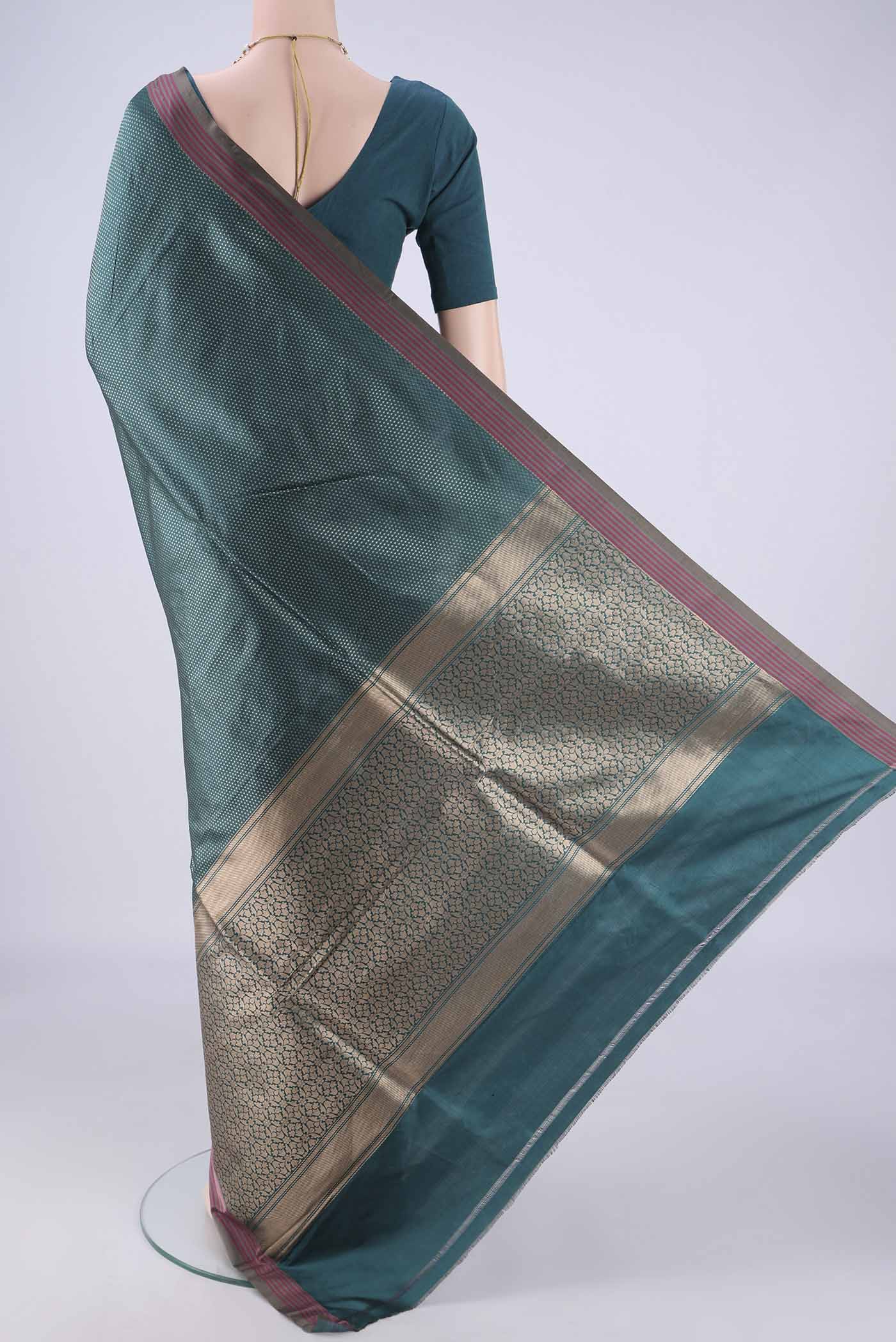 Flat view of Peacock Blue Banarasi Silk Saree with Zari Brocade on the body and Plain Border. 
