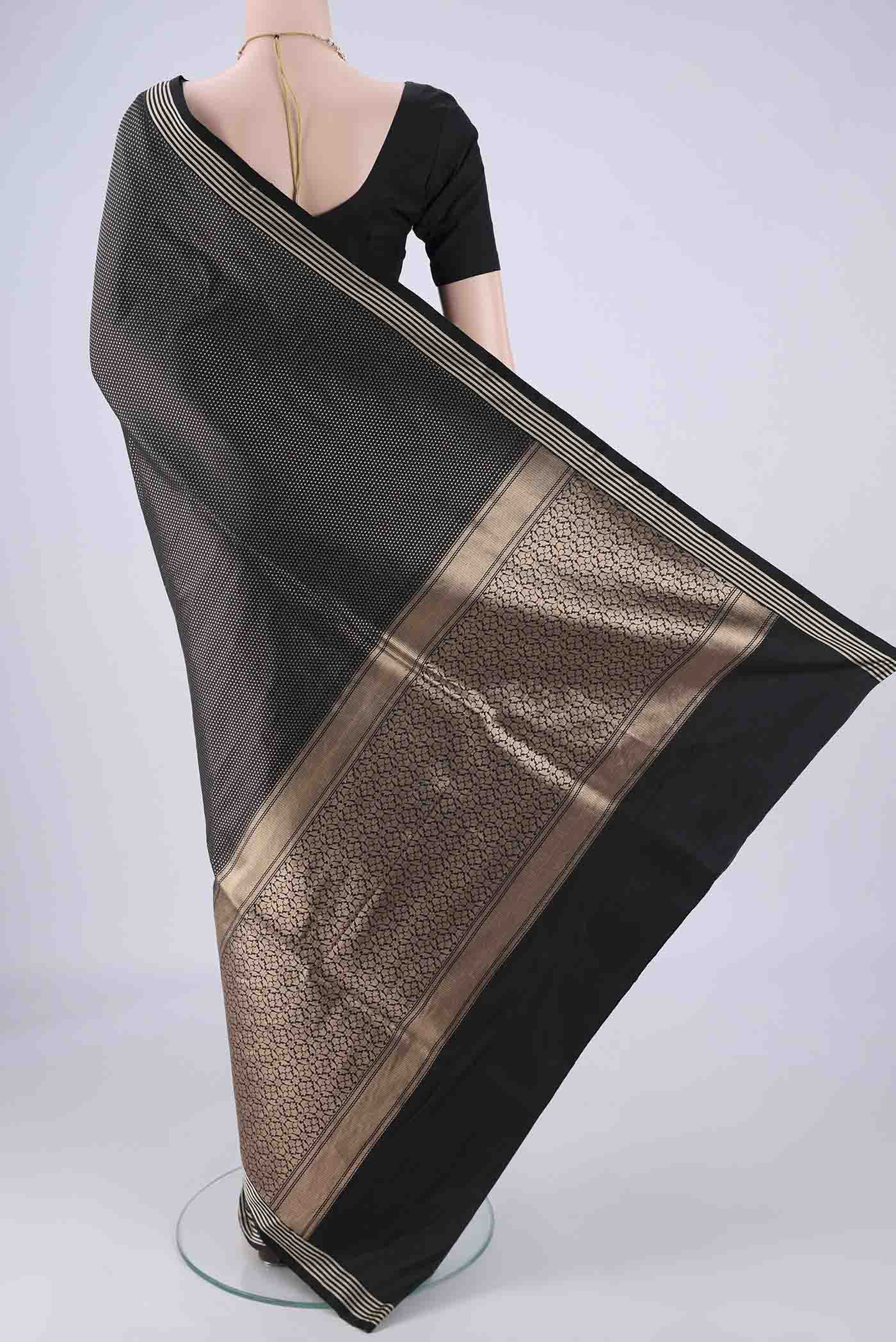 Flat view of Black Banarasi Silk Saree with Zari Brocade on the body and Plain Border. 