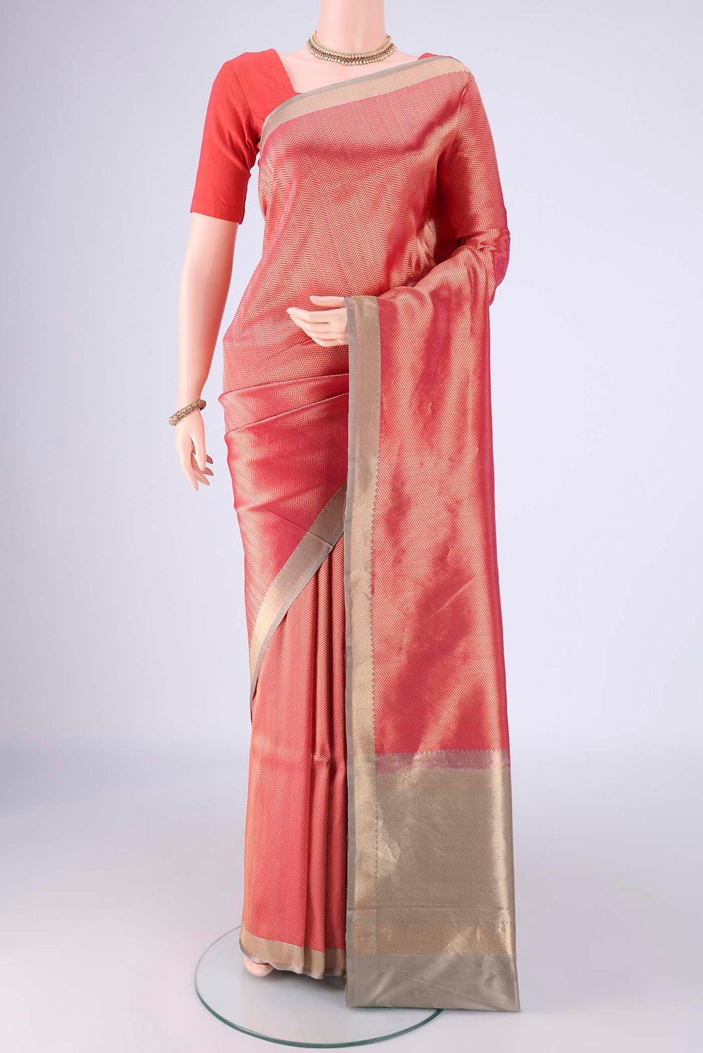 Coral Banarasi Silk Saree with Zari Brocade on the body and Zari Border.  displayed on a mannequin