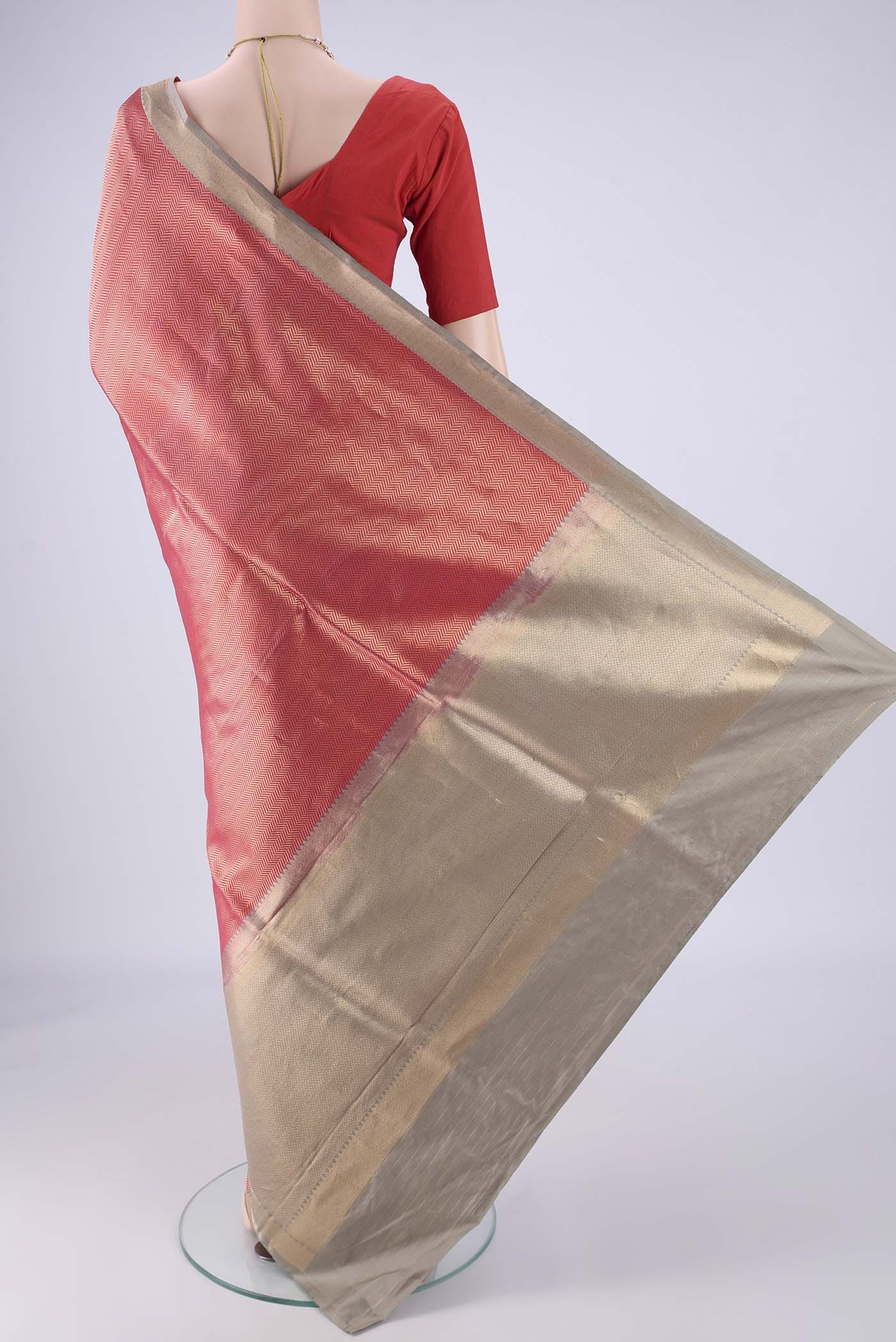 Flat view of Coral Banarasi Silk Saree with Zari Brocade on the body and Zari Border. 