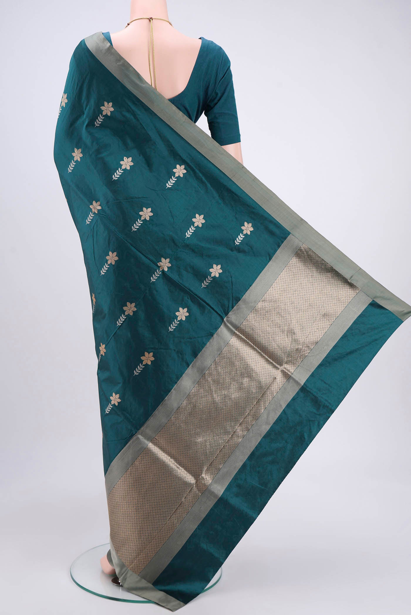 Flat view of Turquoise Banarasi Silk Saree with Zari Butta on the body and Zari Border. 