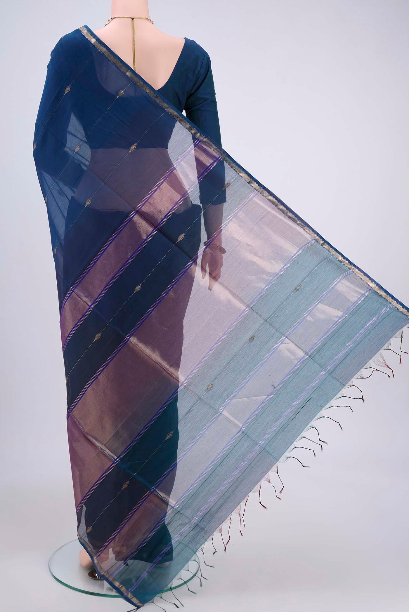 Flat view of Dark Blue Dual Tone Maheshwari Silk Cotton Saree with Thread Butta on the body and Zari Border. 