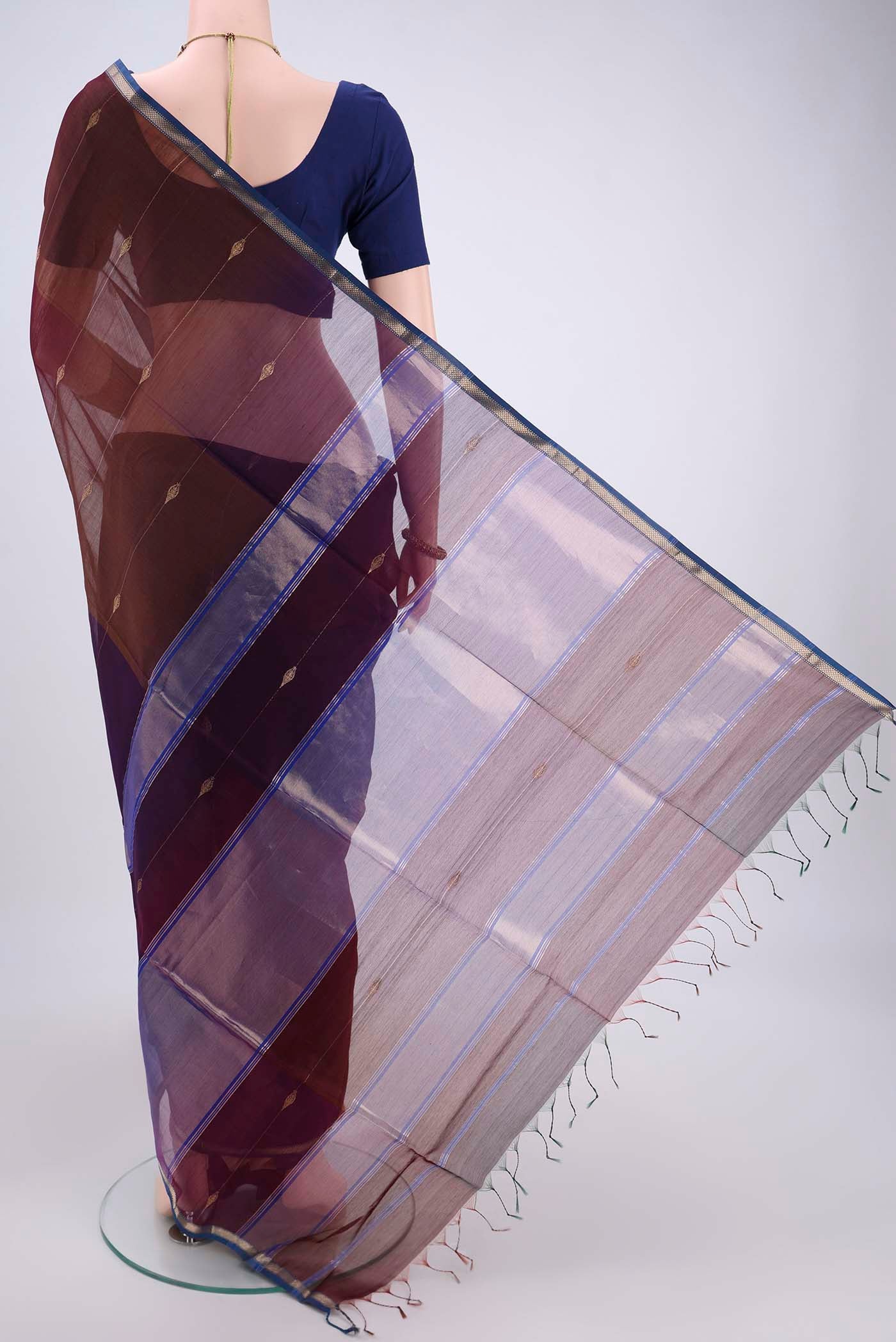Flat view of Brown Maheshwari Silk Cotton Saree with Zari And Thread Butta on the body and Zari Border. 