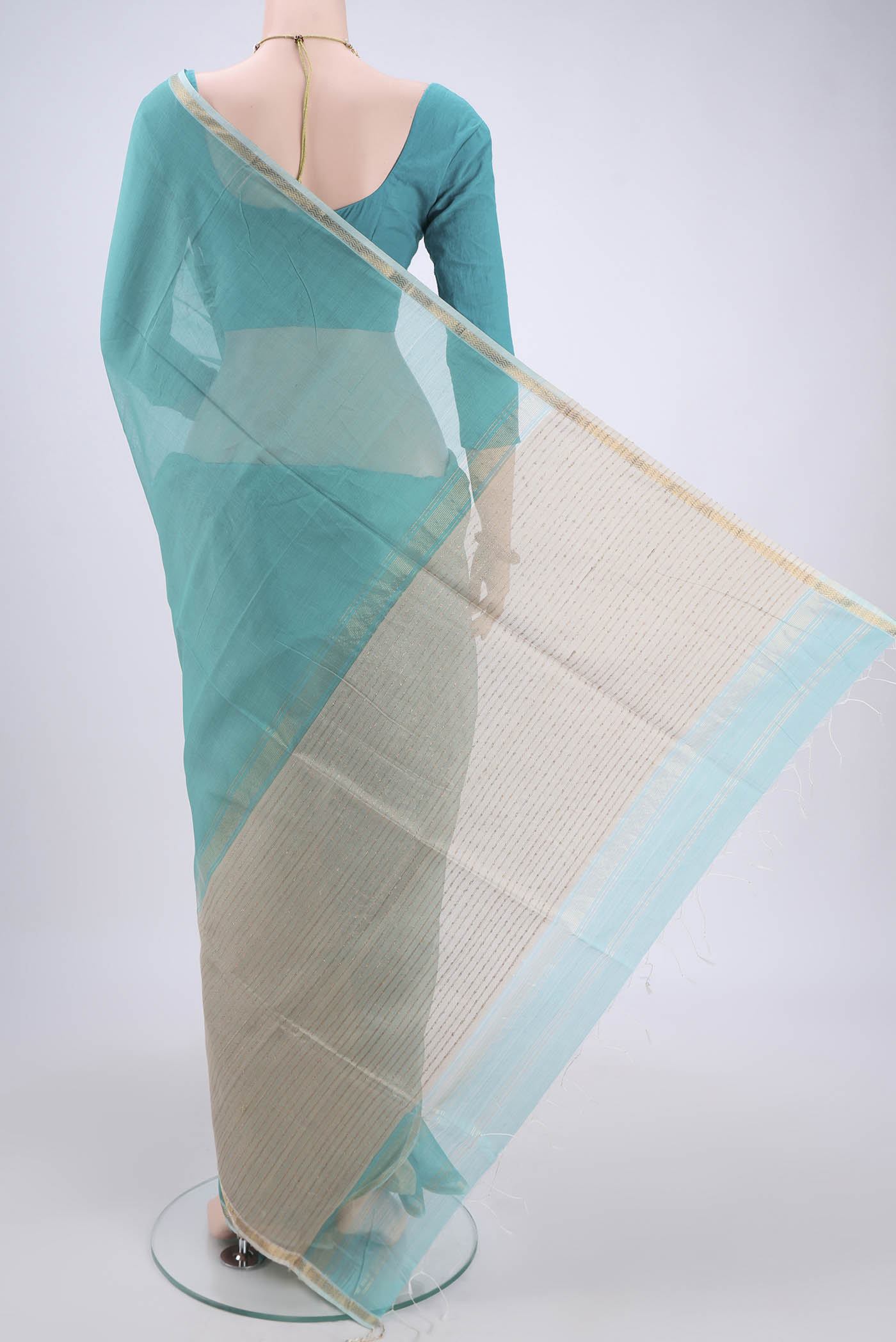 Flat view of Sky Blue Maheshwari Silk Cotton Saree with Zari And Thread Butta on the body and Zari Border. 