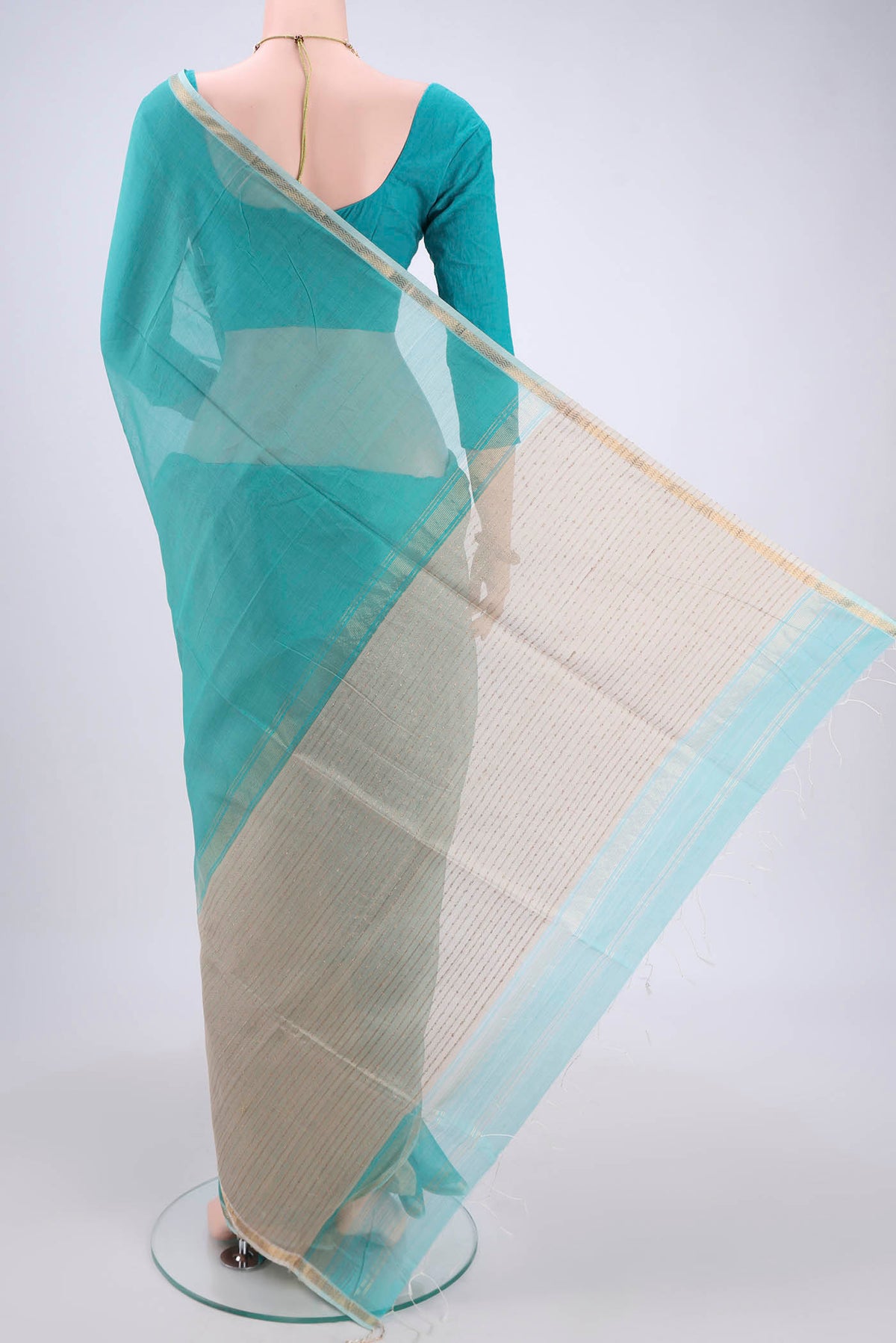 Flat view of Sky Blue Maheshwari Silk Cotton Saree with Zari And Thread Butta on the body and Zari Border. 