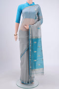 Blue Grey Maheshwari Silk Cotton Saree with Thread Butta on the body and Zari Border.  displayed on a mannequin