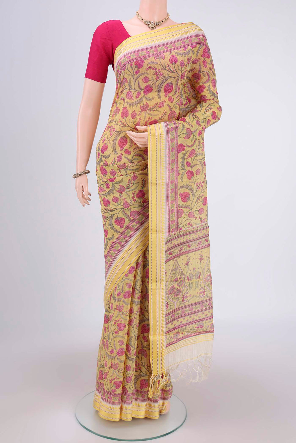 Lemon Yellow Tussar Silk Saree with Floral Print on the body and Thread Border.  displayed on a mannequin