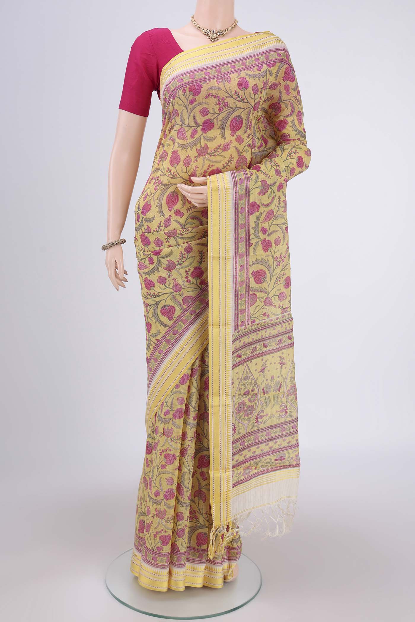 Lemon Yellow Tussar Silk Saree with Floral Print on the body and Thread Border.  displayed on a mannequin