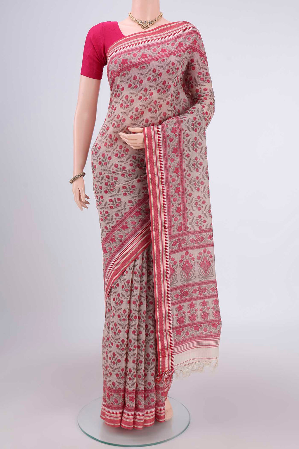 Beige Tussar Silk Saree with Floral Print on the body and Thread Border.  displayed on a mannequin