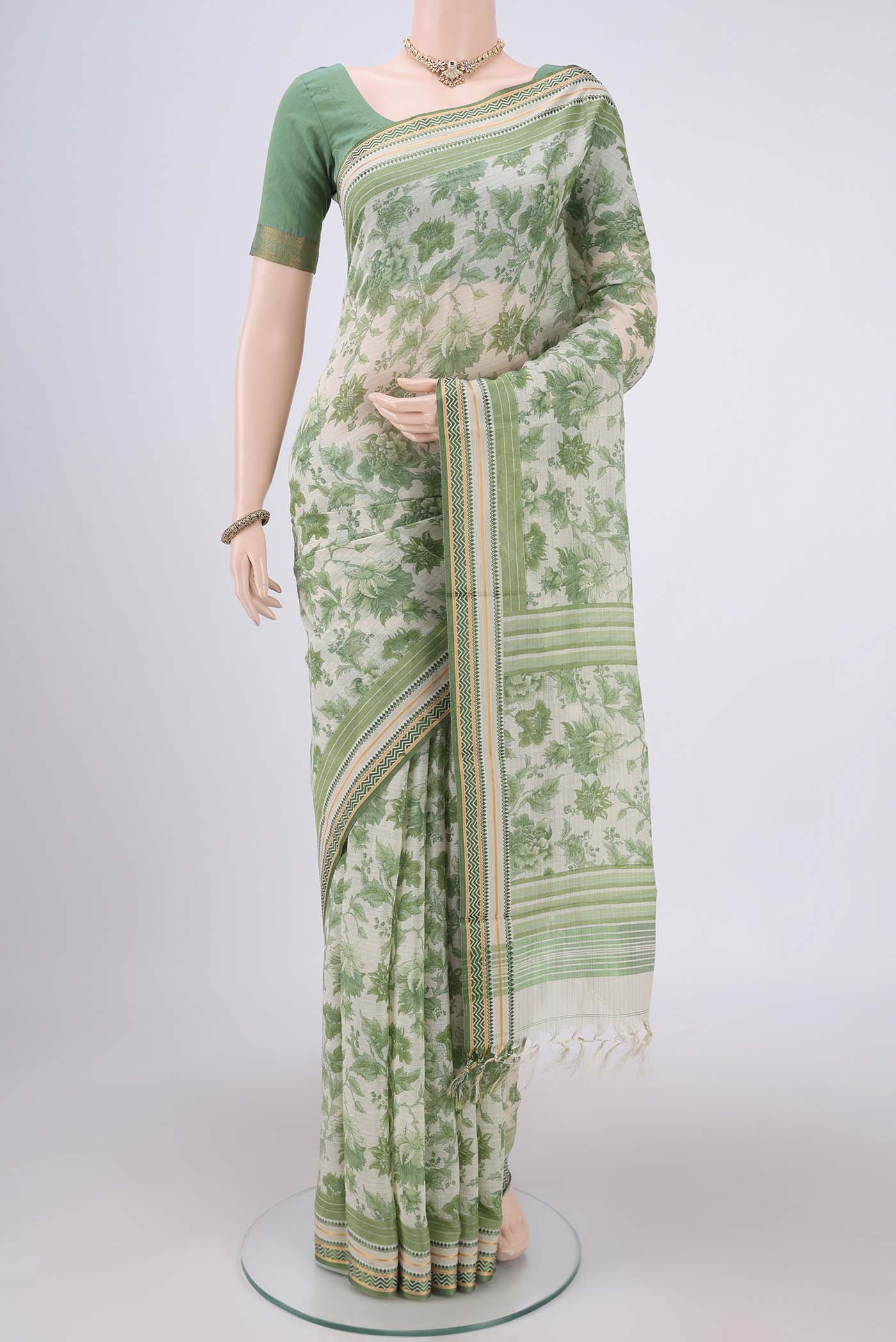 Off White Tussar Silk Saree with Floral Print on the body and Thread Border.  displayed on a mannequin
