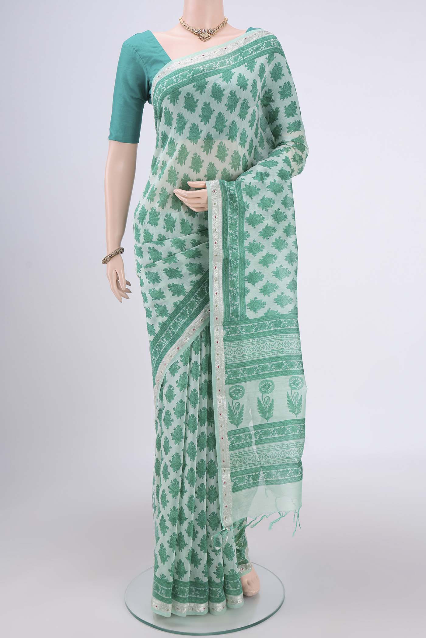 Mint Green Chanderi Silk Saree with Floral Print on the body and Zari Border.  displayed on a mannequin