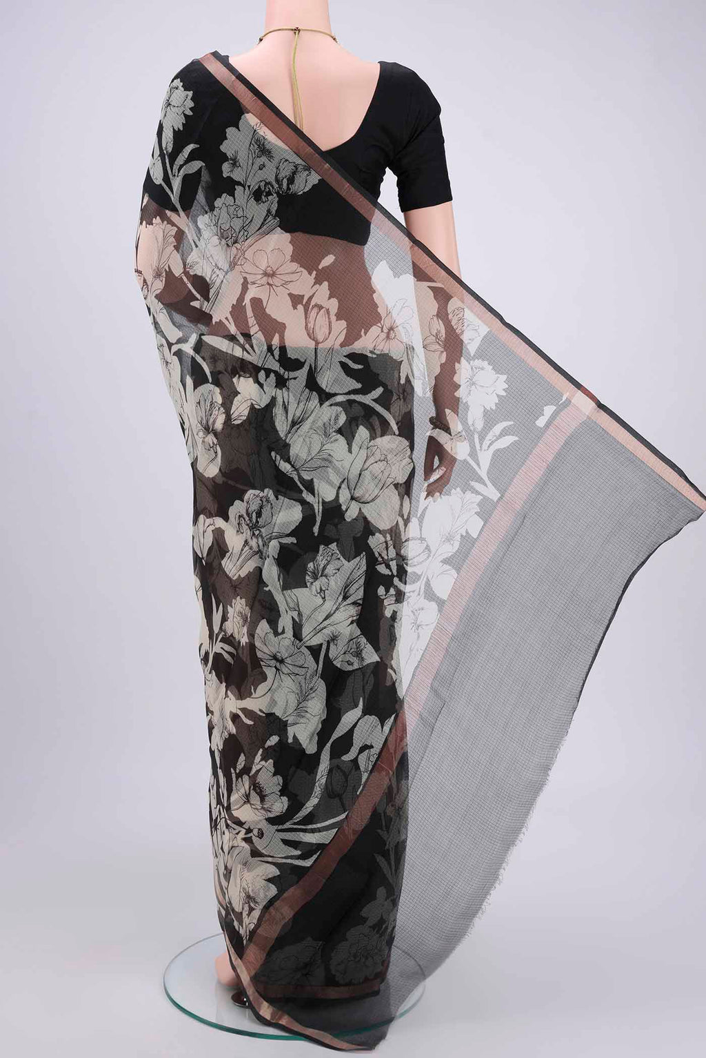 Flat view of Black Kota Silk Saree with Printed design on the body and Zari Border. 