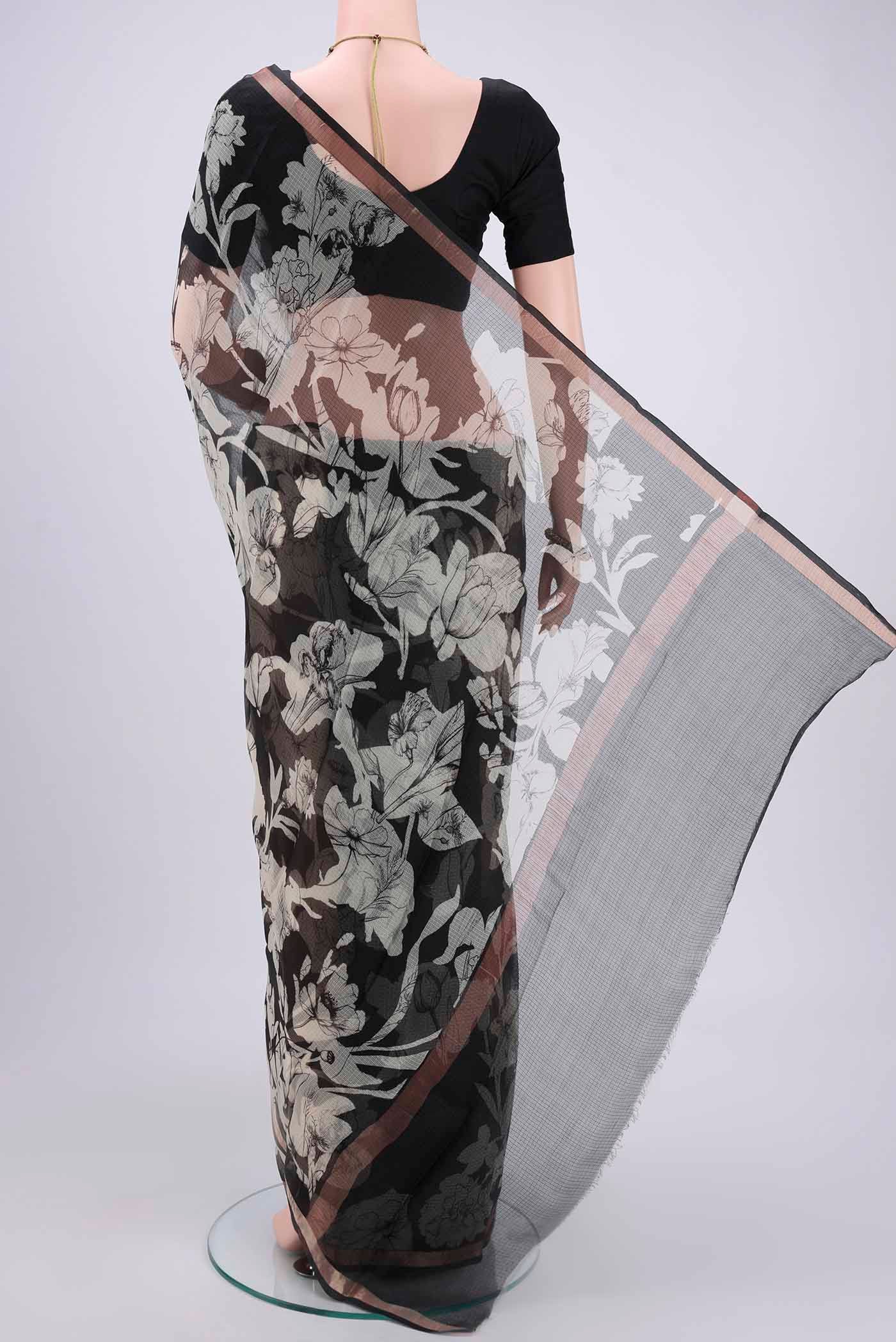 Flat view of Black Kota Silk Saree with Printed design on the body and Zari Border. 