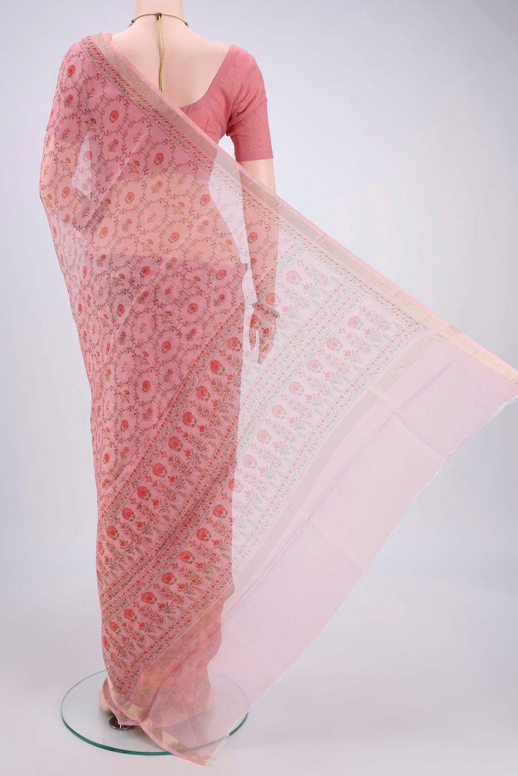 Flat view of Peach Kota Silk Saree with Printed design on the body and Zari Border. 