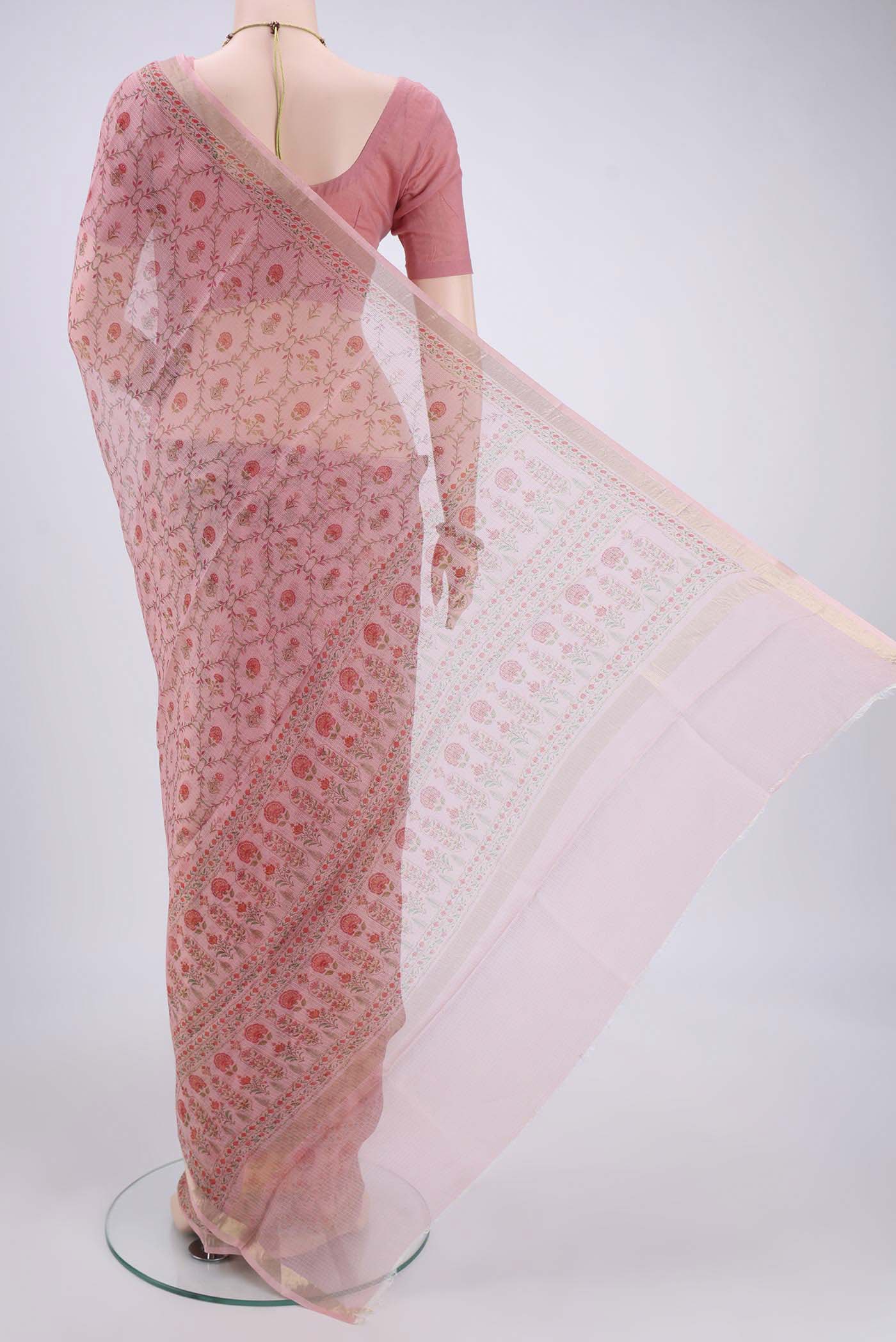 Flat view of Peach Kota Silk Saree with Printed design on the body and Zari Border. 