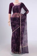 Purple Kota Silk Saree with Floral Print on the body and Zari Border.  displayed on a mannequin