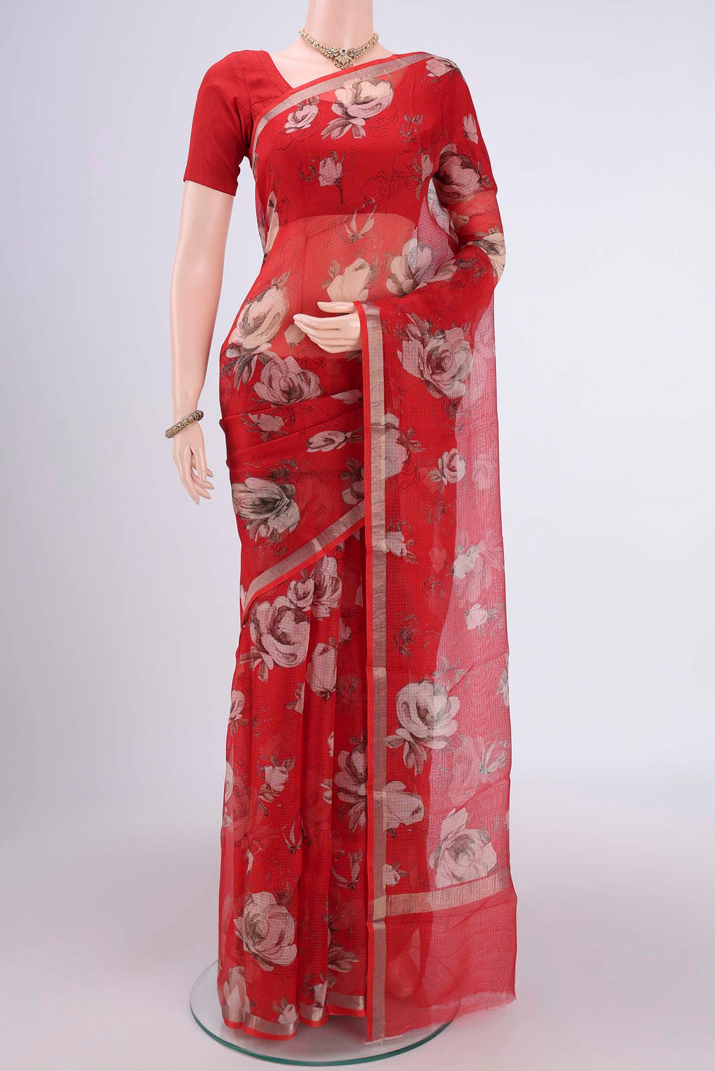 Red Kota Silk Saree with Floral Print on the body and Zari Border.  displayed on a mannequin