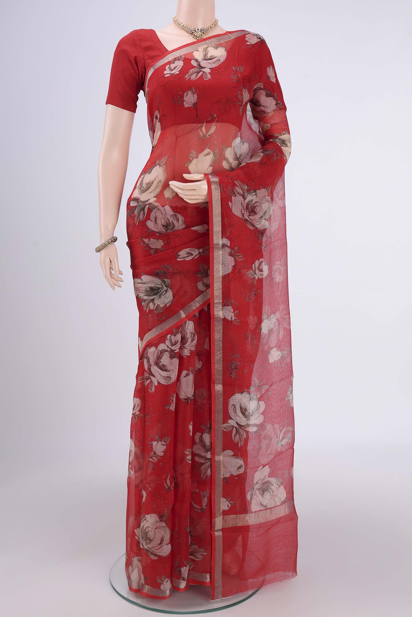 Red Kota Silk Saree with Floral Print on the body and Zari Border.  displayed on a mannequin