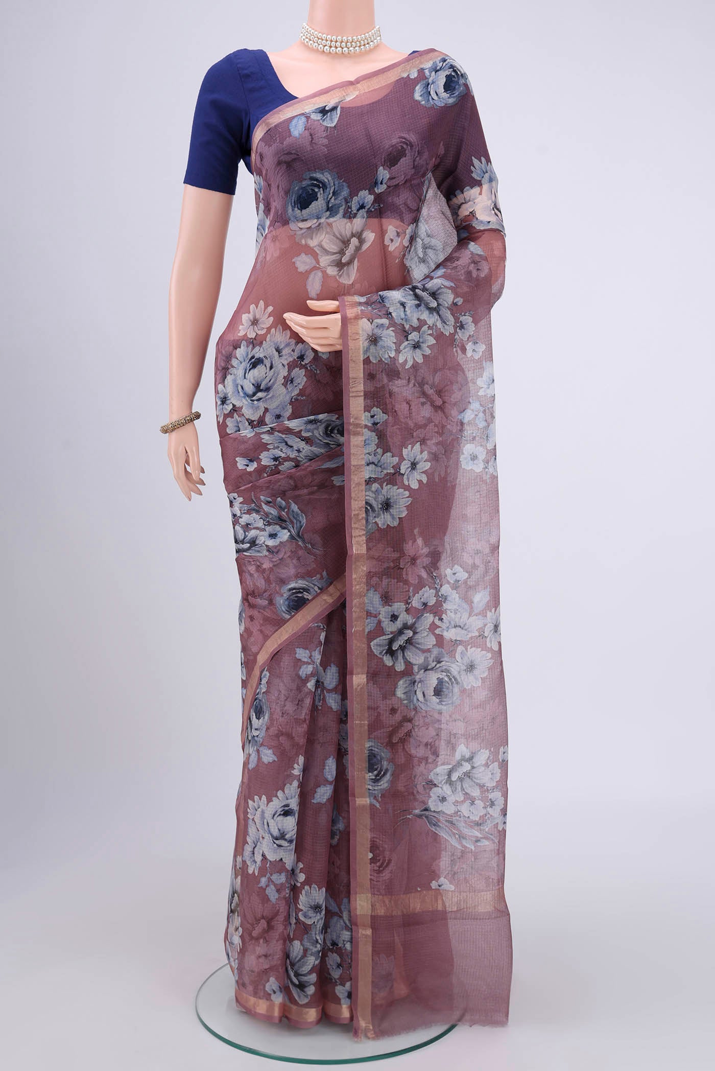 Coral Kota Silk Saree with Printed design on the body and Zari Border.  displayed on a mannequin