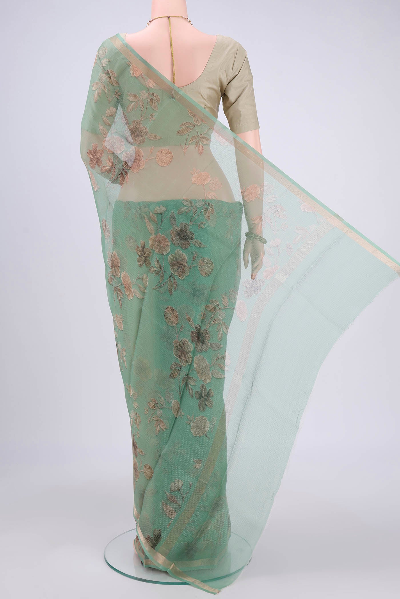 Flat view of Sage Green Kota Silk Saree with Printed design on the body and Zari Border. 