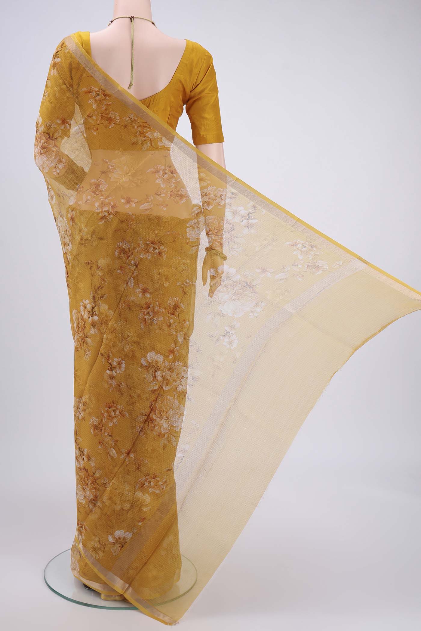 Flat view of Mustard Kota Silk Saree with Printed design on the body and Zari Border. 