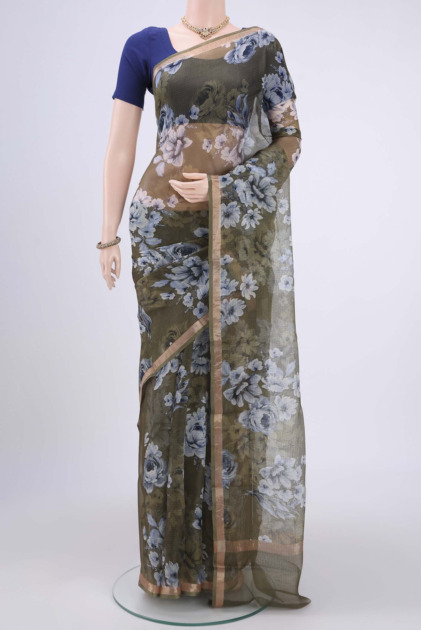 Mehandi Green Kota Silk Saree with Printed design on the body and Zari Border.  displayed on a mannequin