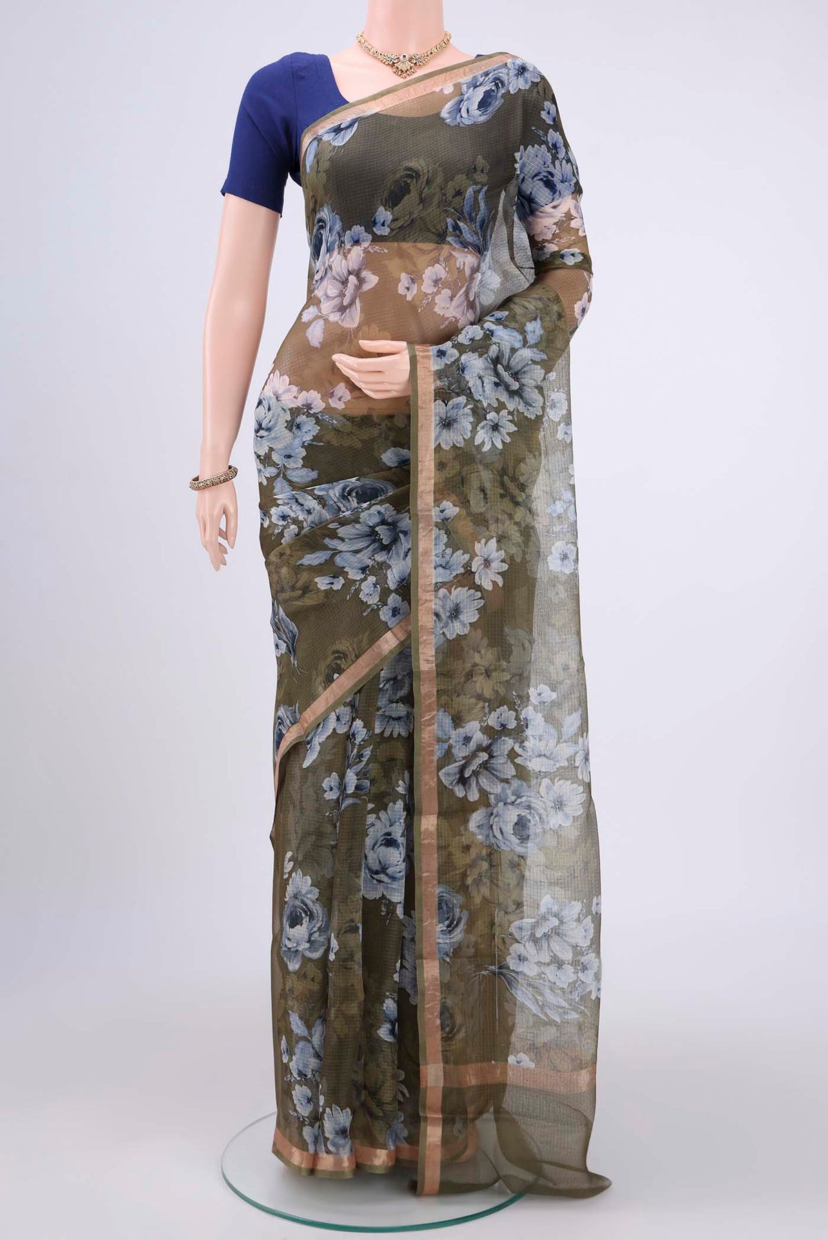 Mehandi Green Kota Silk Saree with Printed design on the body and Zari Border.  displayed on a mannequin
