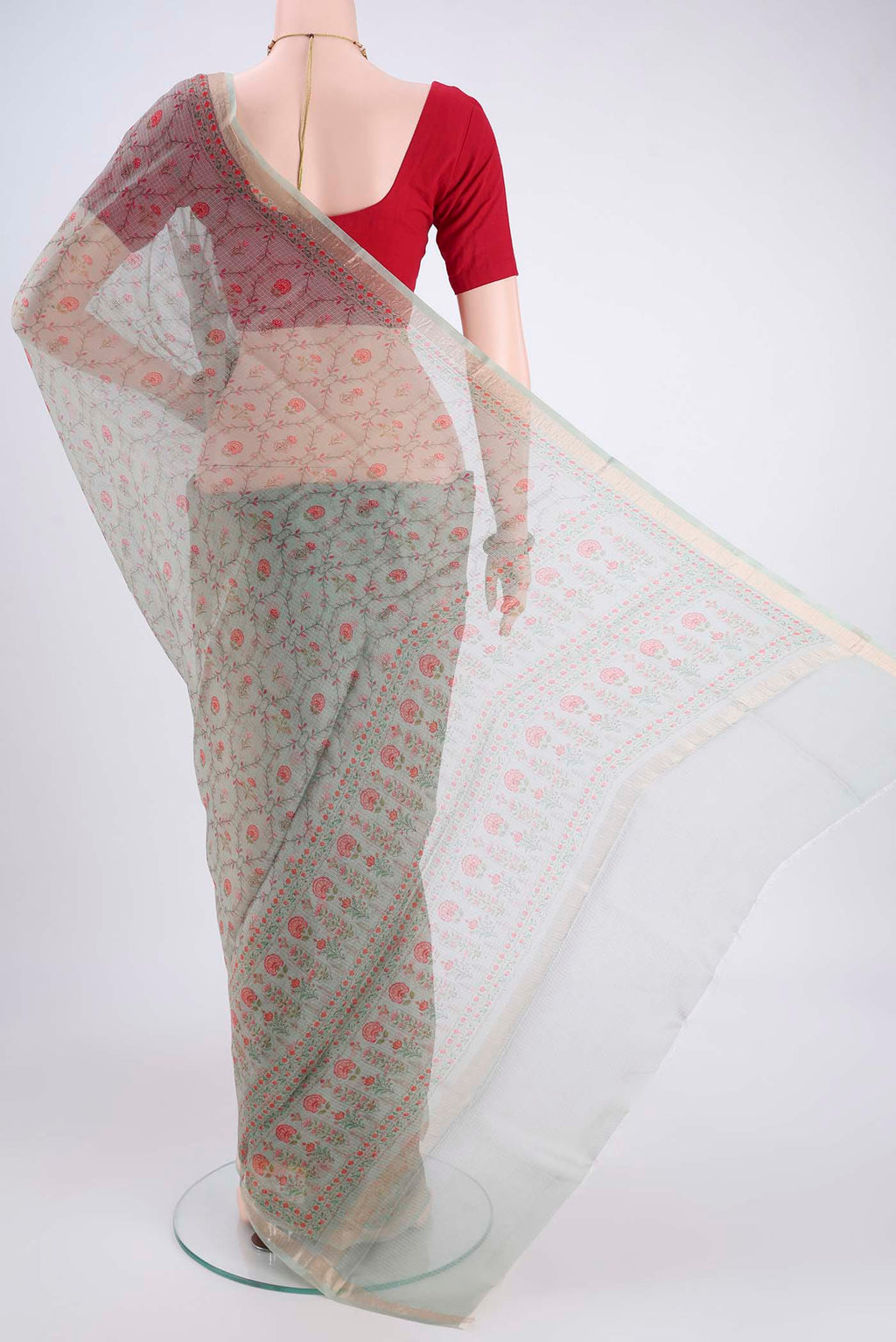 Flat view of Sage Green Kota Silk Saree with Printed design on the body and Zari Border. 