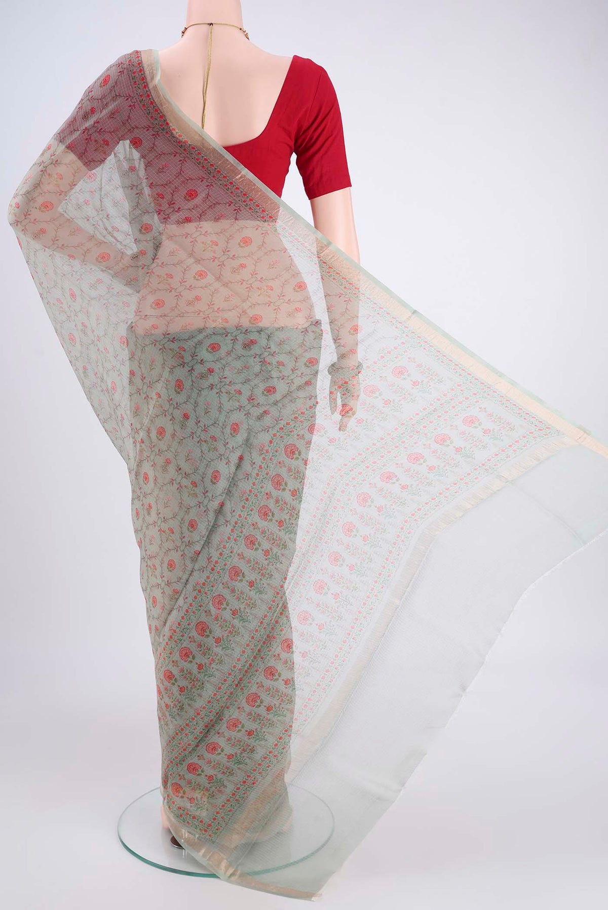 Flat view of Sage Green Kota Silk Saree with Printed design on the body and Zari Border. 