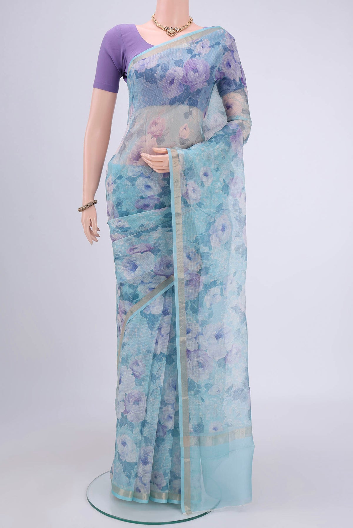 Sky Blue Kota Silk Saree with Printed design on the body and Zari Border.  displayed on a mannequin