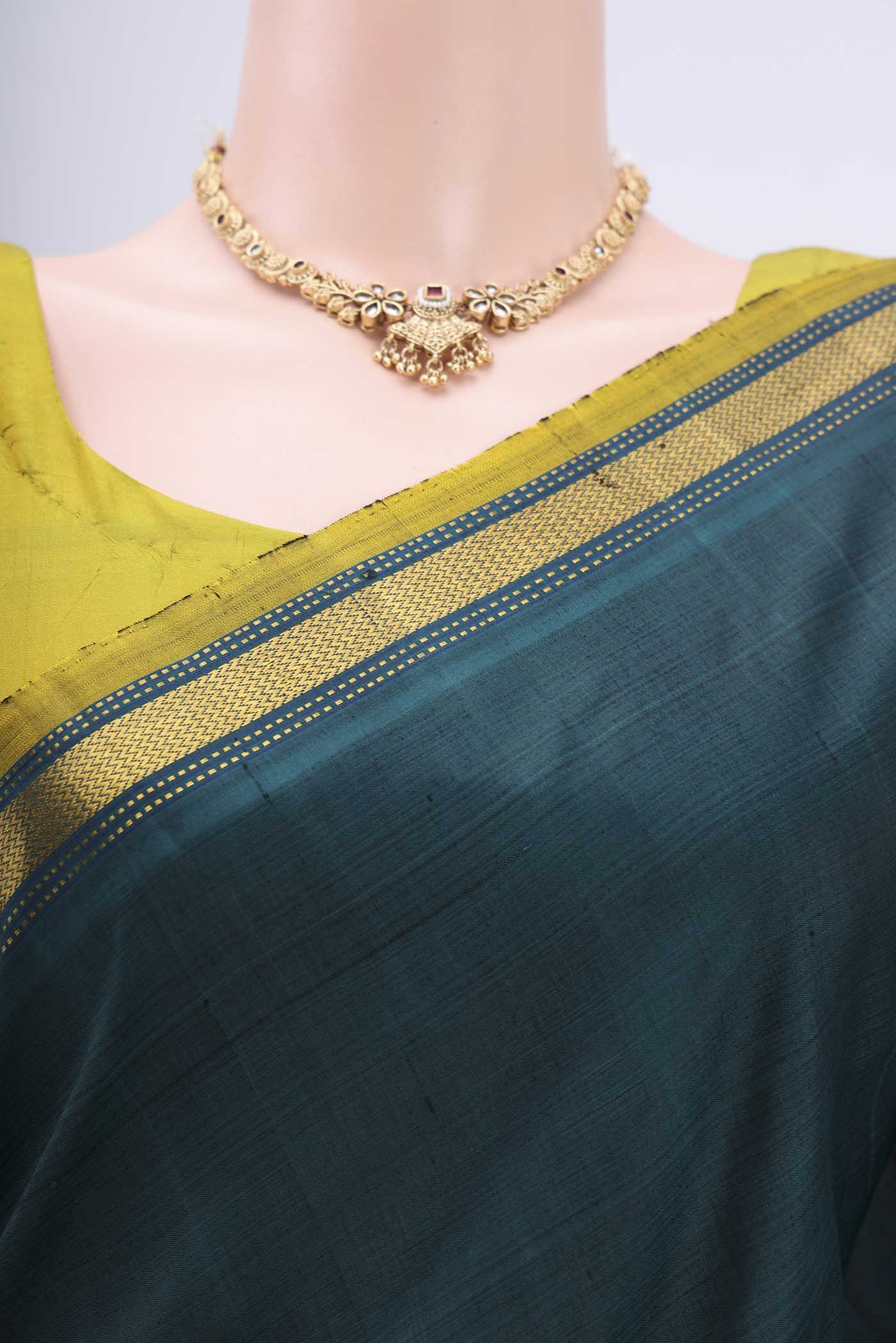 Border image of Bottle Green Kanjivaram Silk Saree with Plain Body and Zari Border. 