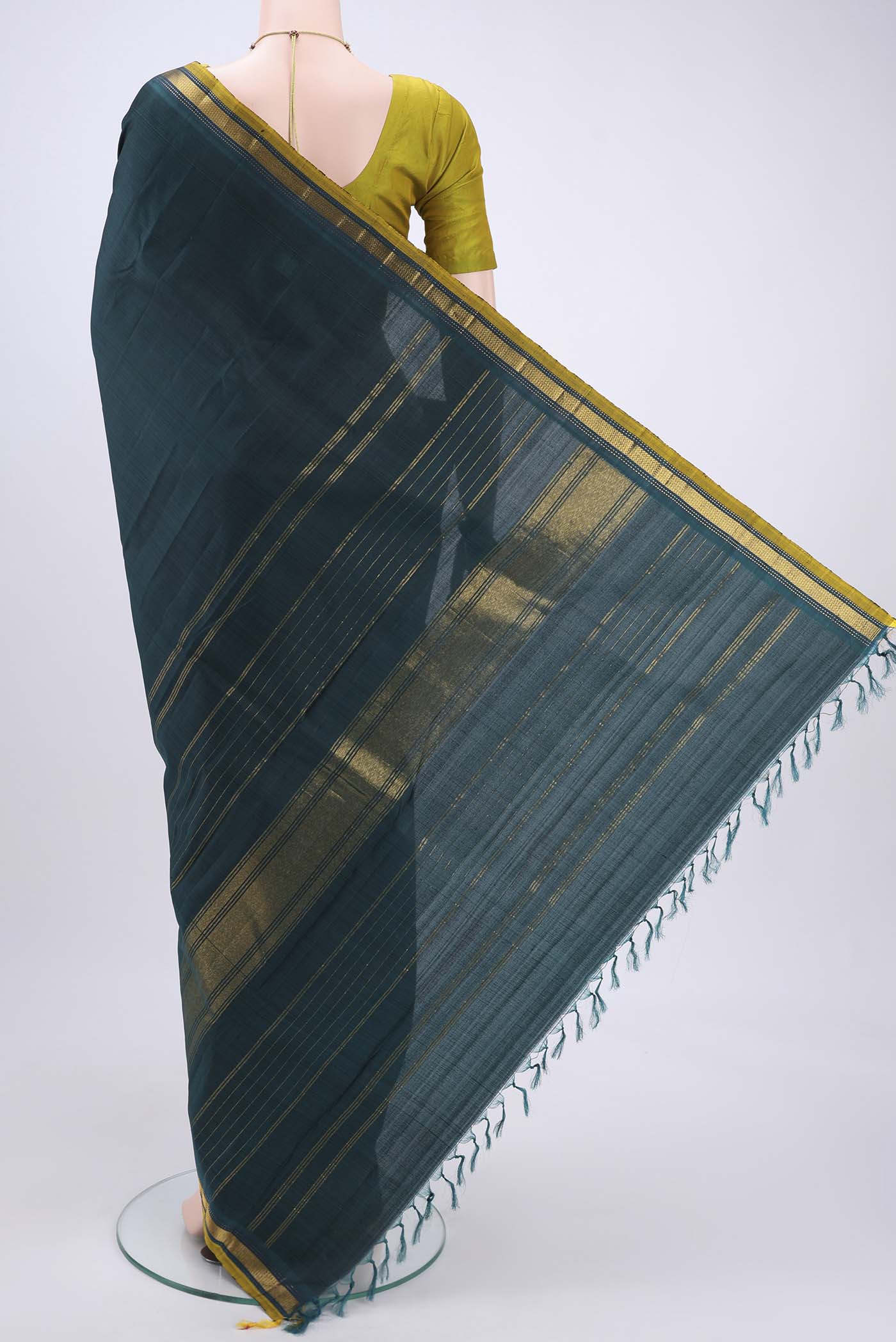 Flat view of Bottle Green Kanjivaram Silk Saree with Plain Body and Zari Border. 